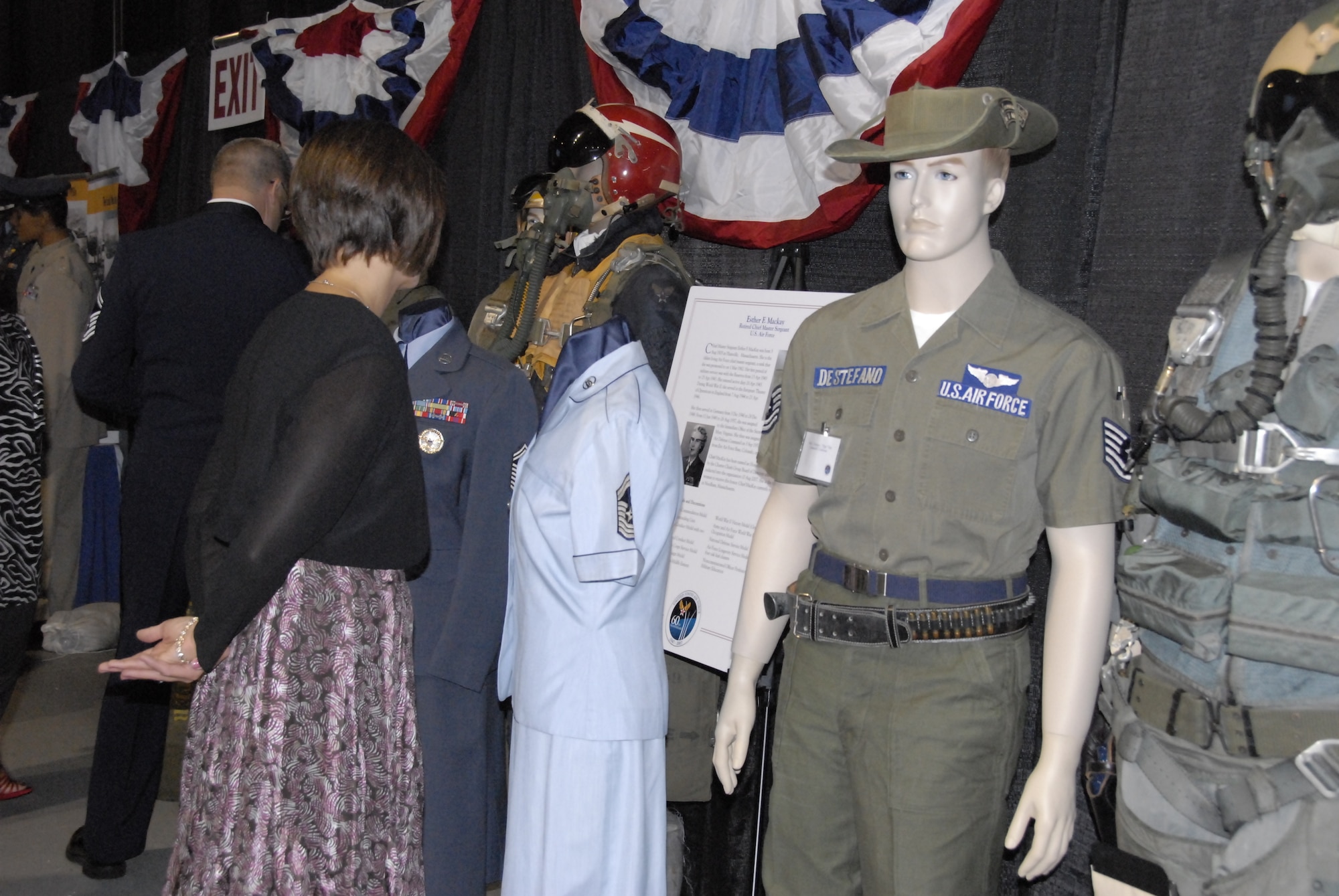 Air Force Ball attendees examine a uniform display themed, “Worn with honor: 60 years of U.S. Air Force uniforms,” which contained 40 samples of uniforms and gear worn from 1947 to present. The display was provided by Will Shaefer, who served in the Army and is now an engineer with the Mitre Corporation. Mr. Shaefer has been collecting and displaying Army and Air Force uniforms for more than 30 years. (U.S. Air Force photo by 2nd Lt. C. Michaela Walrond.)