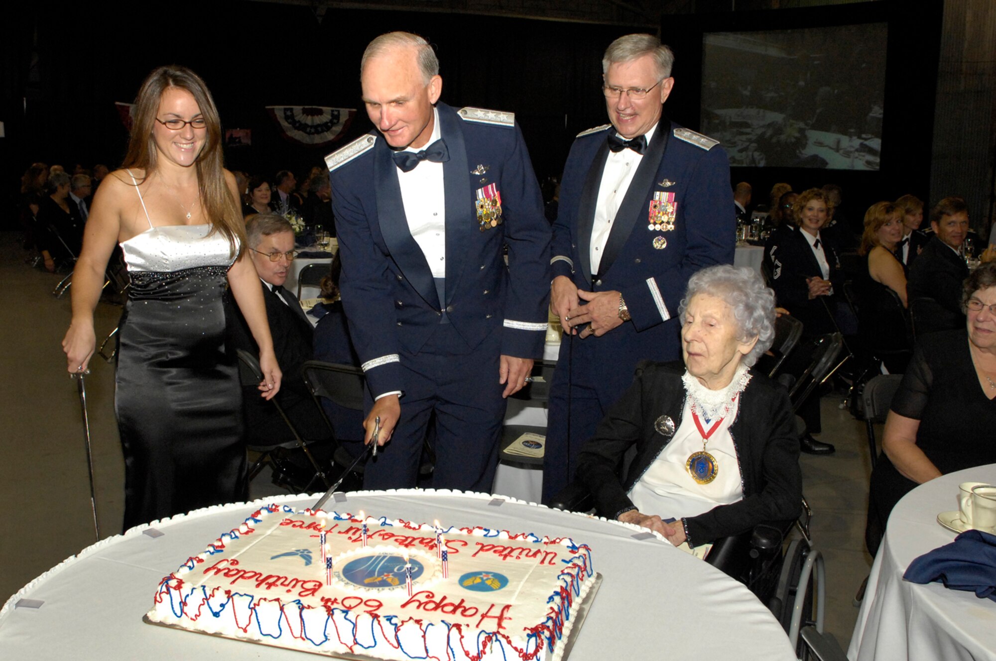 From left, Lee Wyatt Salisbury, Electronic Systems Center Commander Lt. Gen. Chuck Johnson,  Air Force Deputy Chief of Staff for Personnel Lt. Gen. Roger Brady, and retired Chief Master Sergeant Esther MacKay take turns cutting the Air Force Birthday cake during the Air Force Ball Sept. 14. Miss Salisbury joined the Air Force during the ball; her Oath of Enlistment was administered by General Johnson. Chief MacKay, 102, is the oldest living retired Chief Master Sergeant. General Brady was the keynote speaker during the evening. (U.S. Air Force photo by Mark Wyatt.)