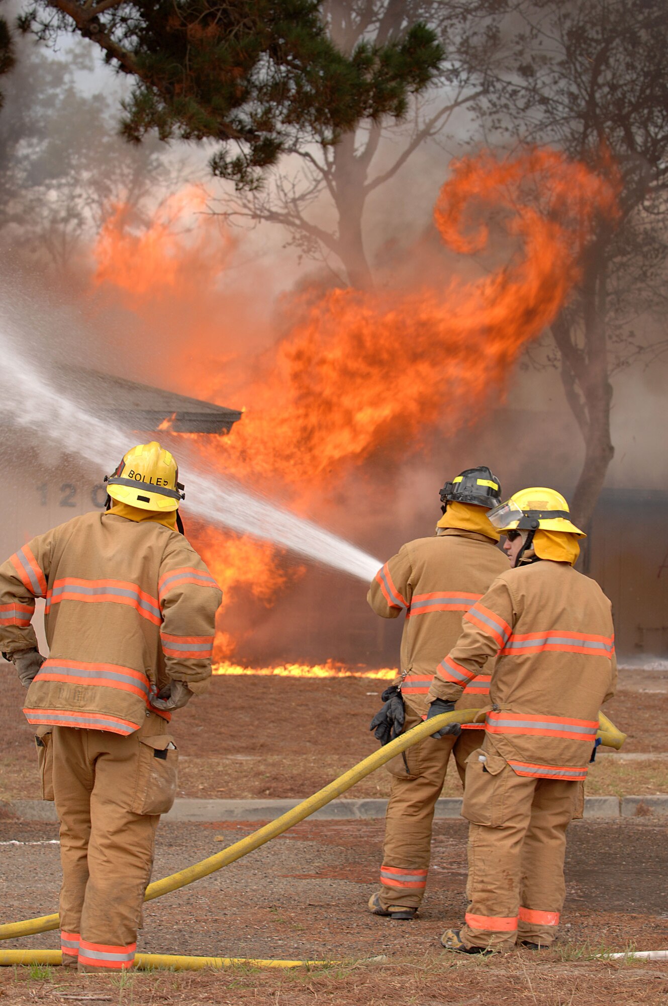 Three Vandenberg fire fighters put out a blaze in east base housing here. Four Vandenberg fire fighters put out a training fire in east base housing here. The 30th Civil Engineer Squadron Fire Protection Flight have five live training fires planned from 8:30 a.m. to 8 p.m. between Sept. 14 and Oct. 1. The training will consist of live fire training inside a residential structure and will give the firefighters the opportunity to get first-hand knowledge of fire behavior as well as the specific stages of fire growth in safer, controlled environment. (U.S. Air Force photo by Staff Sgt. Vanessa Valentine)