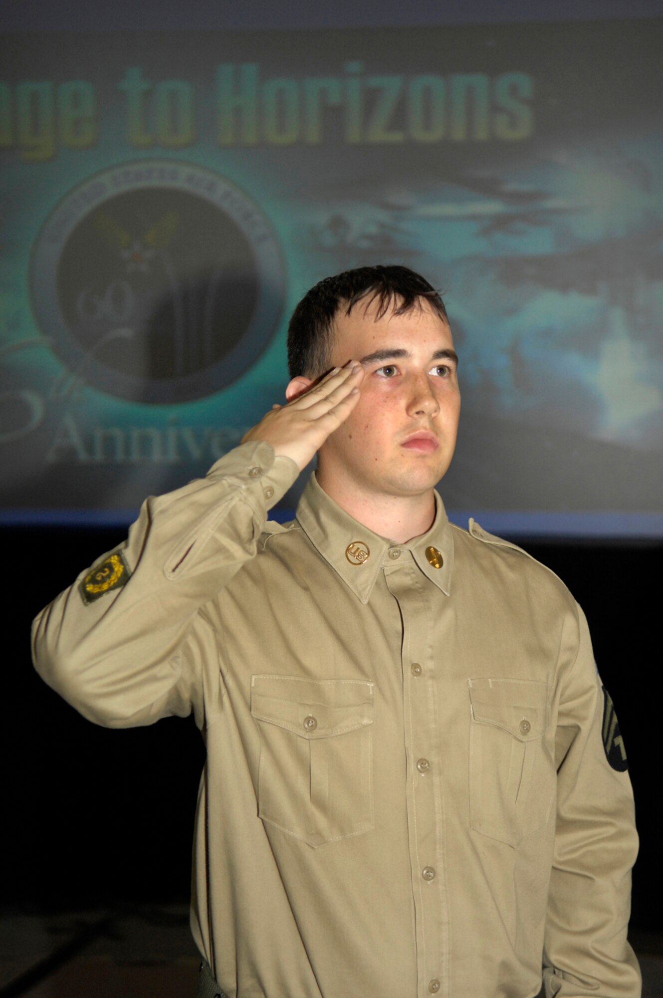 Senior Airman Jeremy Bridges, 66th Comptroller Squadron, renders a salute during the POW/MIA ceremony Sept. 14 at the Air Force 60th Anniversary Ball. Students from the Airmen Leadership School dressed in period uniforms and performed the solemn ceremony to honor the prisoners of war and those missing in action throughout the Air Force’s history. (U.S. Air Force photo by Mark Wyatt.)
