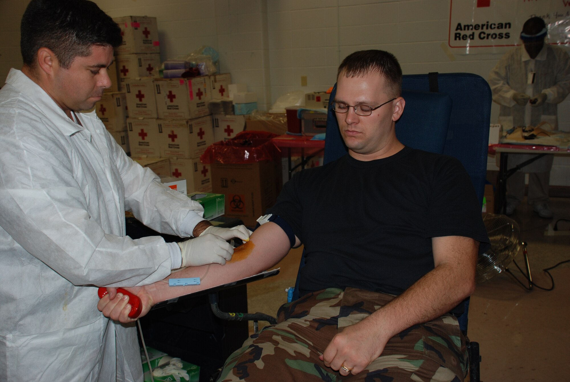 Staff Sgt. Michael Champion (right), a student at the 381st Training Squadron, sits still as Valentine Vasquez from the American Red Cross inserts a needle during the Sept. 18-19 blood drive. Sheppard members donated 359 units of blood. (U.S. Air Force photo/John Ingle)