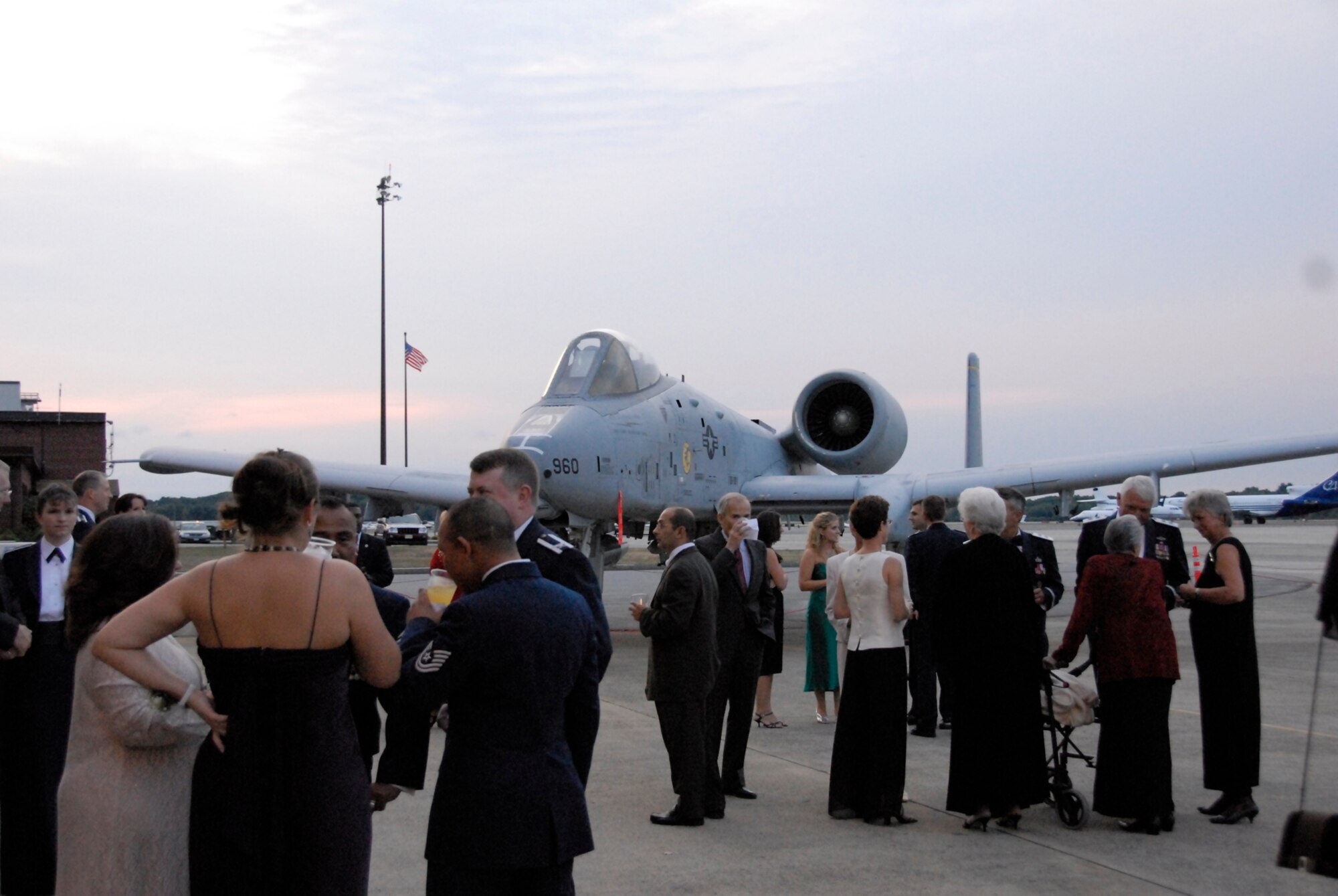 Attendees of Hanscom’s 60th Anniversary Air Force Ball mingle outside of the Aero Club Hangar near static displays of vintage aircraft Sept. 14. Guests were able to get an up-close look at the F-16 Fighting Falcon, A-10 Thunderbolt II and T-6 Texan. More than 650 people attended the event. (U.S. Air Force photo by 2nd Lt. C. Michaela Walrond.)