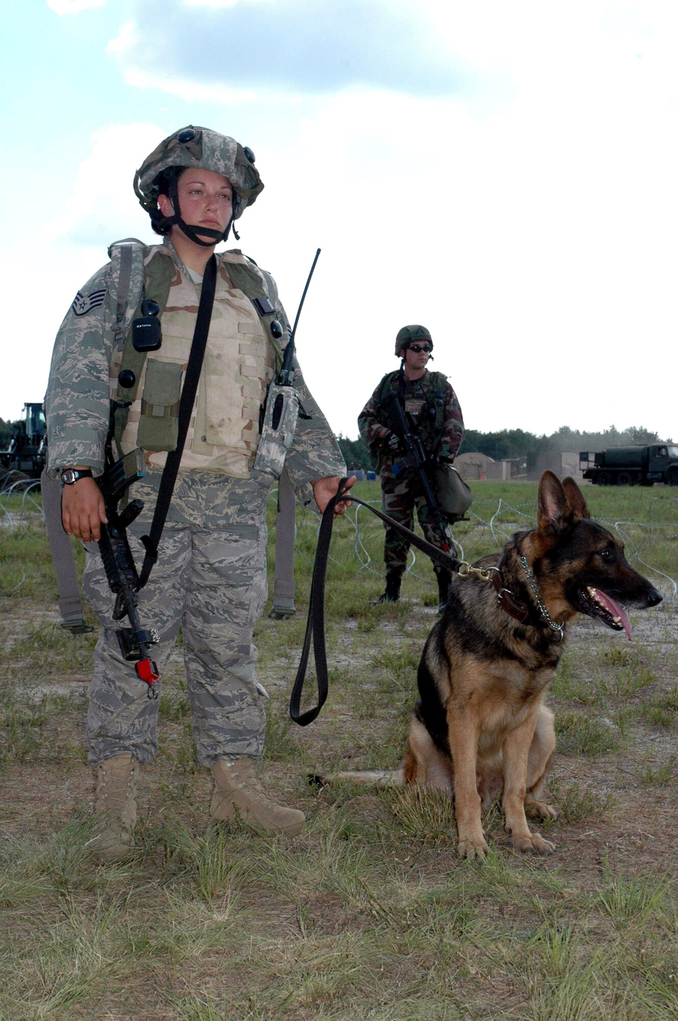 Staff Sgt. Pamela Lowande and her military working dog, Ziko, participate in a scenario Aug. 28 during Air Force Exercise Eagle Flag 07-6 at Naval Air Engineering Station Lakehurst, N.J. They were Phoenix Warrior students participating in the exercise. The exercise is operated by the U.S. Air Force Expeditionary Center's 421st Combat Training Squadron from Fort Dix, N.J.  Sergeant Lowande and Ziko are from the 81st Security Forces Squadron at Keesler Air Force Base, Miss.  (U.S. Air Force photo/Tech. Sgt. Scott T. Sturkol)