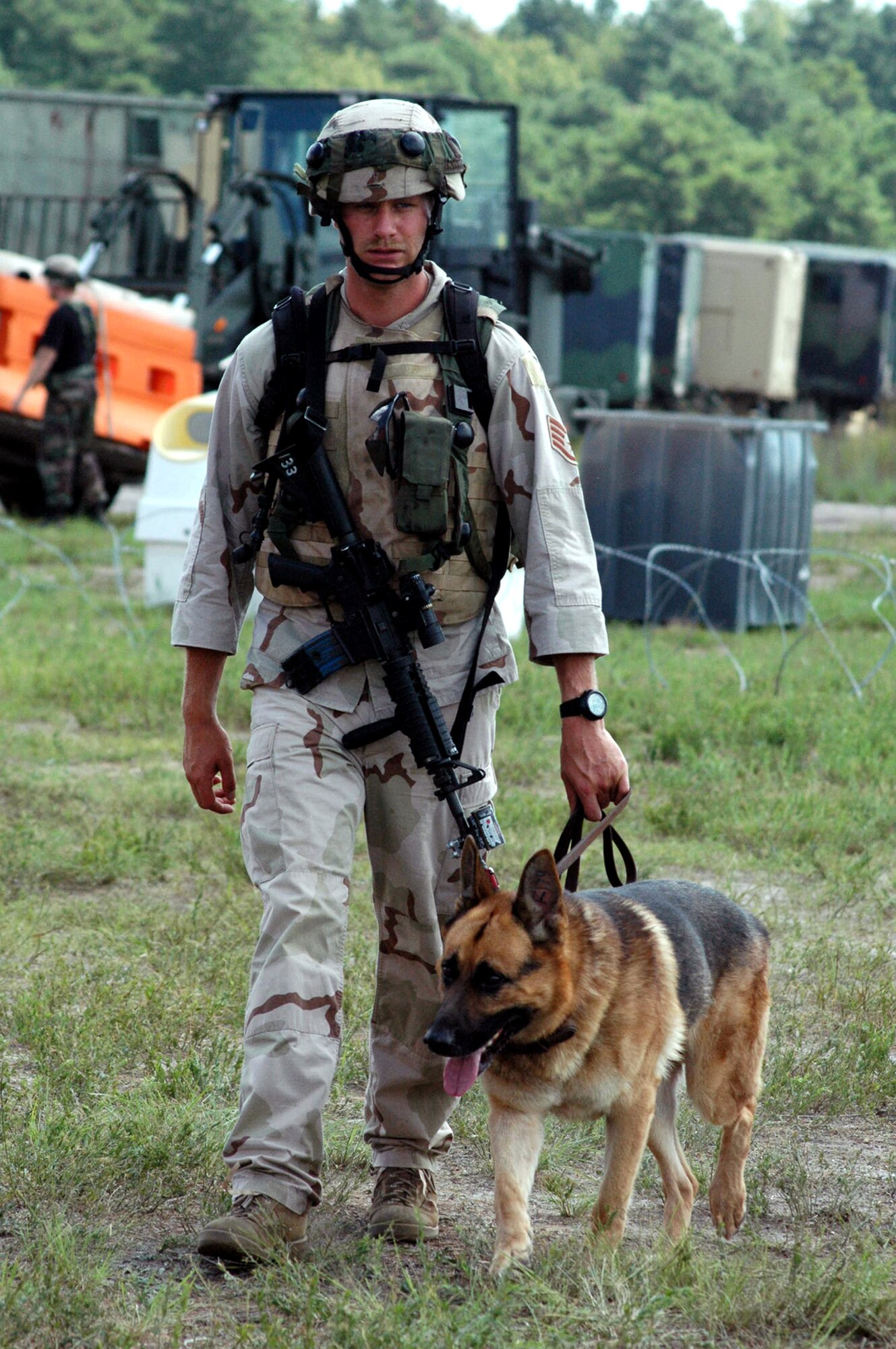 Staff Sgt. Andrew Goligowski and his military working dog, Endy, participate in a scenario Aug. 28 during Air Force Exercise Eagle Flag 07-6 at Naval Air Engineering Station Lakehurst, N.J.  They were Phoenix Warrior students participating in the exercise.  The exercise is operated by the U.S. Air Force Expeditionary Center's 421st Combat Training Squadron from Fort Dix, N.J.   Sergeant Goligowski and Endy are from the 319th Security Forces Squadron at Grand Forks Air Force Base, N.D.  (U.S. Air Force photo/Tech. Sgt. Scott T. Sturkol)