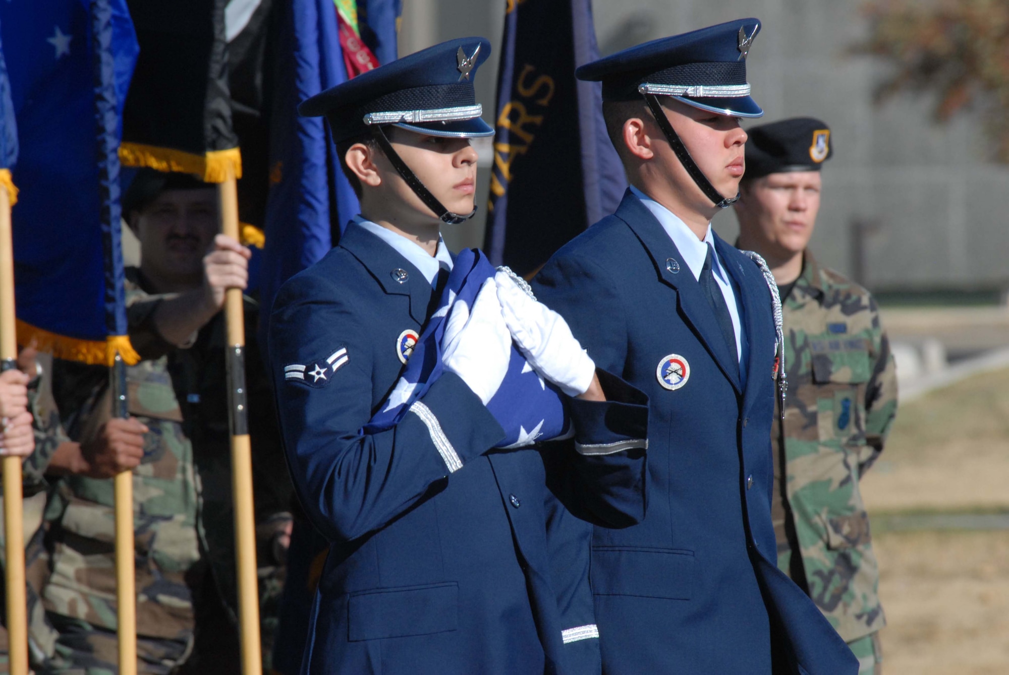 Members of Malmstrom's Honor Guard Airman 1st Clas Joshua Montoya, left, and Senior Airman Neil Young, right,  wait to present the colors to Col. David Durgan, commander of troops, at the POW/MIA Remembrance Ceremony Sept. 21. (U.S. Air Force photo/John Turner)