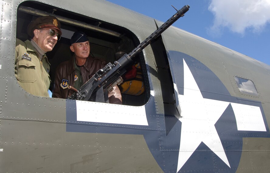 As part of the Collings Foundation’s “Wings of Freedom Tour,” Frank Tedesco, left, tour stop coordinator at Plymouth Municipal Airport, shows Electronic Systems Center Commander Lt. Gen. Chuck Johnson a .50 caliber gun aboard a B-24J Liberator -- the only restored flying B-24 in the world. The “Wings of Freedom Tour” showcases aircraft nationwide with the purpose of honoring veterans and educating visitors on the planes. Mr. Tedesco, who flew 35 missions with the 15th Air Force during his time in service, has volunteered as a tour organizer for nine years. (U.S. Air Force photo by Jan Abate.)