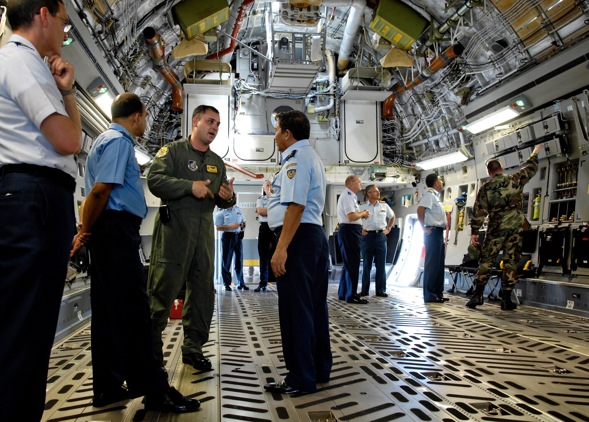 Capt. Jason Ward discusses the C-17 Globemaster III with members of the Pacific Rim Airpower Symposium Sept. 20, 2007 at Hickam Air Force Base, Hawaii. The PACRIM Symposium provides an ideal forum to communicate the value of U.S. engagement with nations of the Asia-Pacific region and our commitment to the region to internal, local, national and regional audiences. Capt. Ward is a pilot with the 535th Airlift Squadron. (U.S. Air Force photo/Tech. Sgt. Shane A. Cuomo)