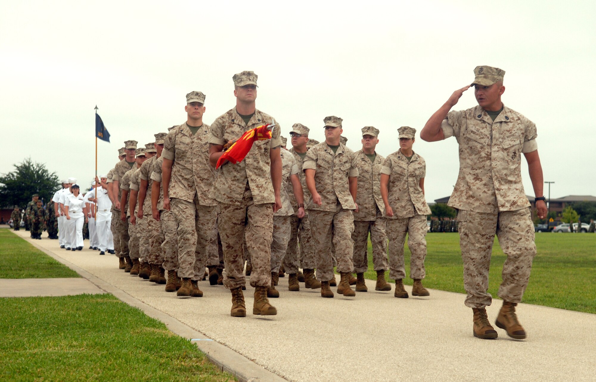 Marines from the Goodfellow Marine Corps Detachment pass in review during the parade portion of the Sept. 11 ceremony. Members of the Army, Navy and Marine Corps marched alongside Airmen from the 17th Training Wing during the ceremony. (U.S. Air Force photo by Airman 1st Class Kamaile Chan)