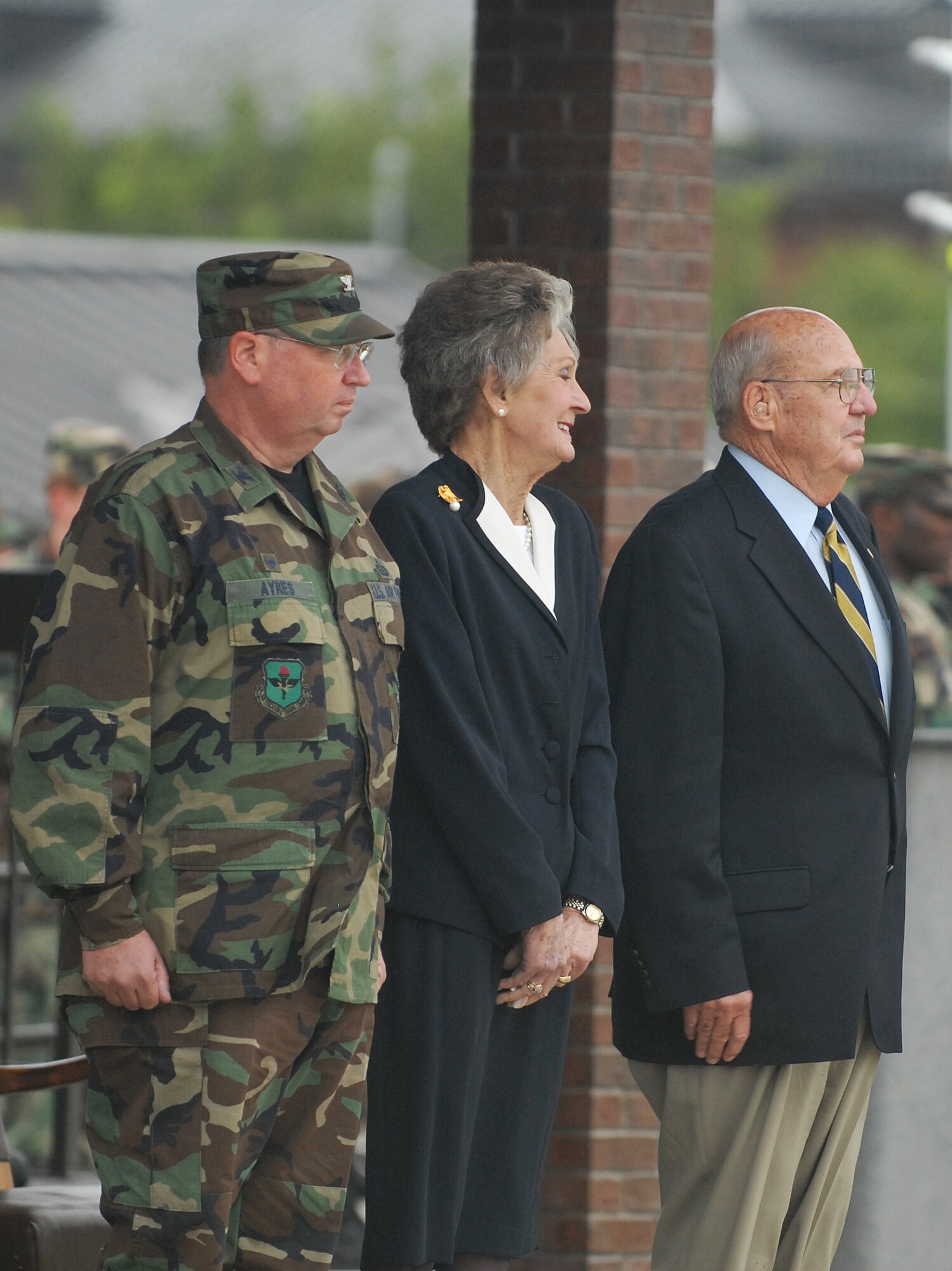 From left to right, Col. Richard Ayres, 17th Training Wing Commander; JoAnne Powell and retired Col. Charlie Powell stand at attention during the playing of the Armed Forces Medley Sept. 11. Colonel and JoAnne Powell were recognized for their continuing service and dedication to the people of Goodfellow Air Force Base. (U.S. Air Force photo by Tech. Sgt. Gina O’Bryan)