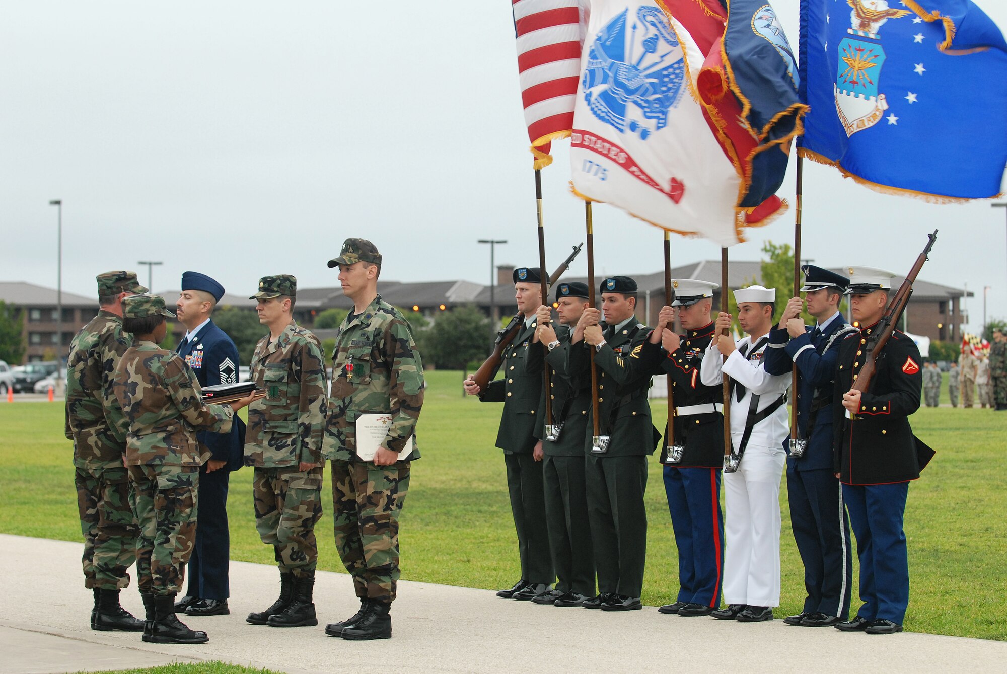 Col. Richard Ayres, 17th Training Wing commander, presents the Bronze Star medal to Chief Master Sgt. Ronald Gallegos, Maj. Jonas Skinner and Lt. Col. Will Roberts during the pass in review ceremony Sept. 11 while the Goodfellow Joint Color Guard stand at attention. (U.S. Air Force photo by Tech. Sgt. Gina O’Bryan)