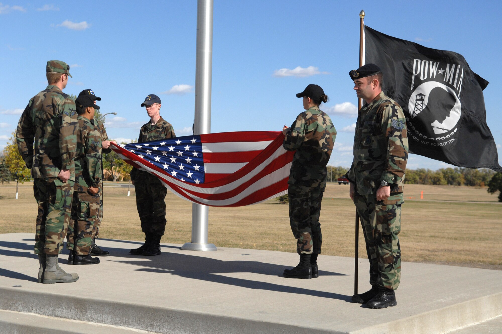 MINOT AIR FORCE BASE, N.D. -- Airmen fold the U.S. flag as part of a retreat ceremony during a POW/MIA ceremony here Sept. 21. The ceremony was designed to honor those who have lost their lives or are still missing in action. (U.S. Air Force photo by Airman 1st Class Cassandra Jones)