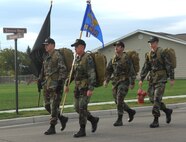 MINOT AIR FORCE BASE, N.D. -- A ruck-march team carrying a POW/MIA flag, led by Maj. Jay Block, 91st Maintenance Group (far left), marches down Sirocco Drive here Sept. 21. The ruck march began at 7:30 a.m.; it was divided into 30-minute segments and lasted until 4:30 p.m. The march honored men and women who have lost their lives or are still missing in action. (U.S. Air Force photo by Airman 1st Class Sharida Bishop)