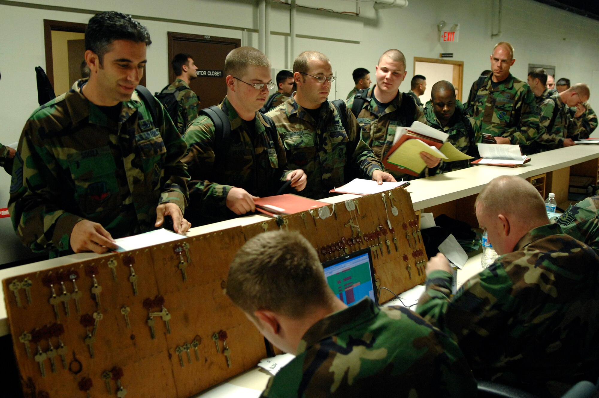 U.S. Air Force Airmen from the 7th Bomb Wing, Dyess Air Force Base (AFB), Texas, in-process and receive keys to their rooms at Ellsworth AFB, S.D., Sept. 20, 2007. Ellsworth will temporarily house an additional 550 Airmen and 20 B-1 aircraft during the repair of 6,600 feet of runway at Dyess. (U.S. Air Force photo by SSgt Michael B. Keller)