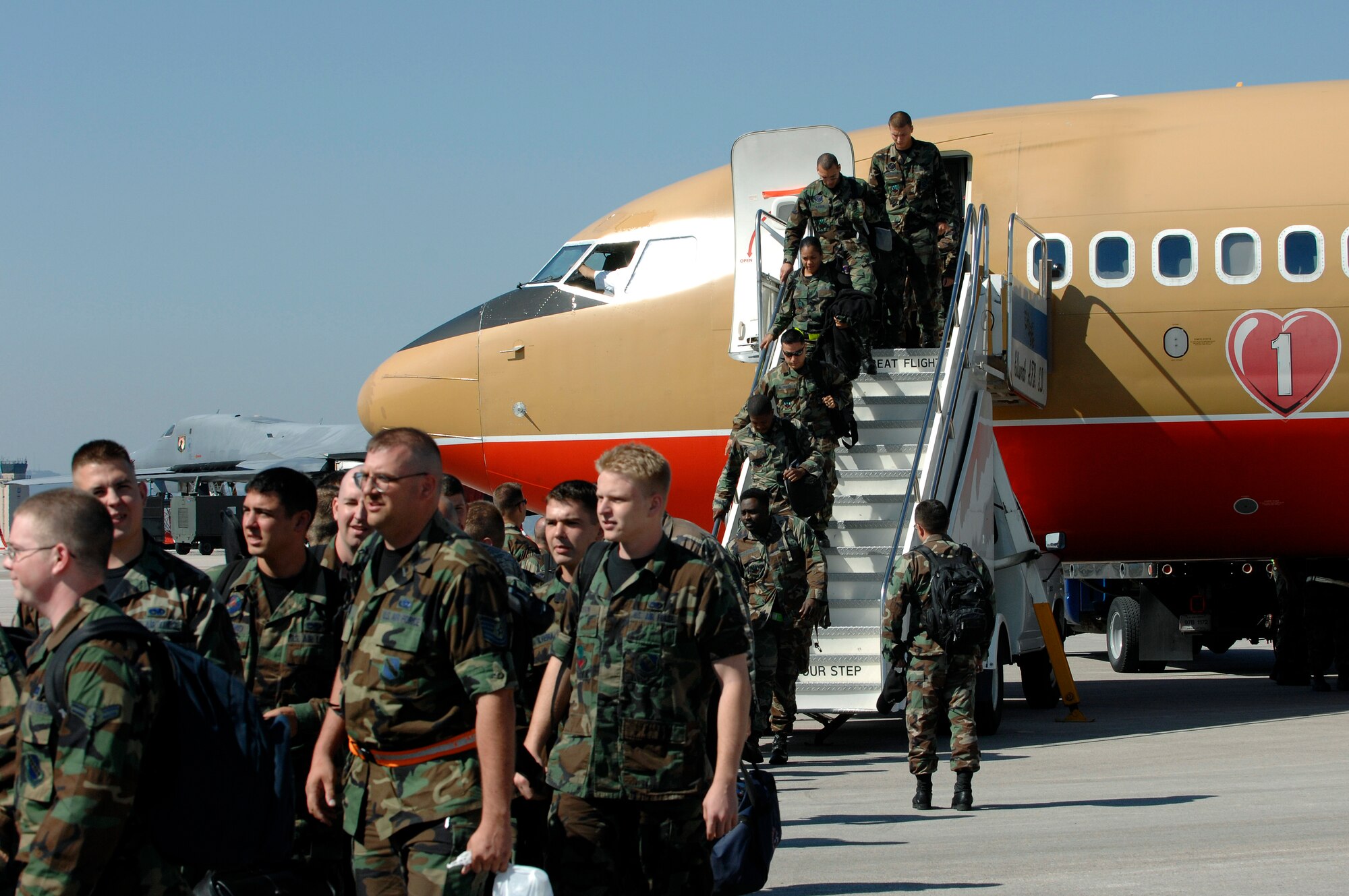 U.S. Air Force Airmen from the 7th Bomb Wing, Dyess Air Force Base (AFB), Texas, exit an aircraft on the flightline at Ellsworth AFB, S.D., Sept. 20, 2007. Ellsworth will temporarily house an additional 550 Airmen and 20 B-1 aircraft during the repair of 6,600 feet of runway at Dyess. (U.S. Air Force photo by SSgt Michael B. Keller)