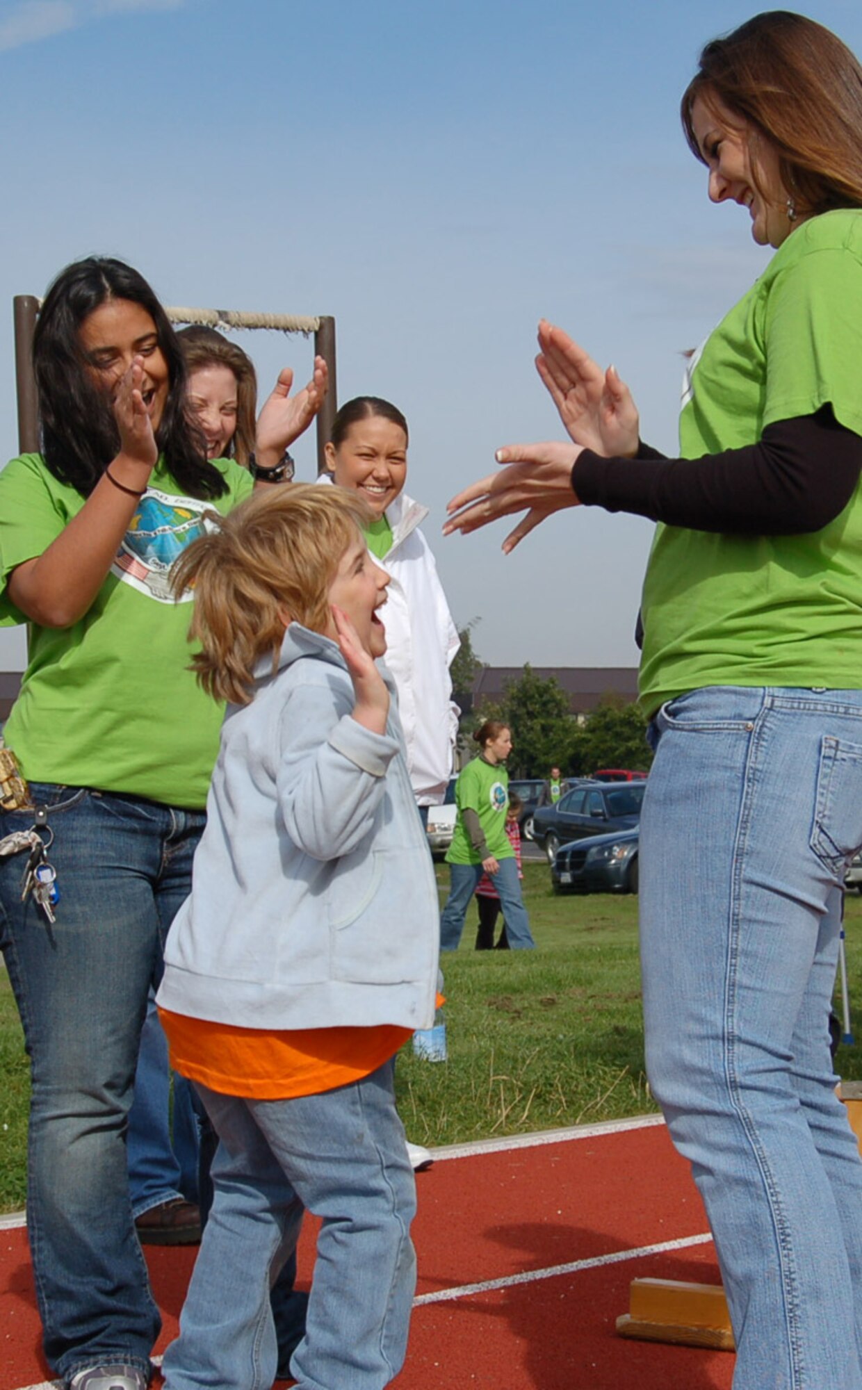 SPANGDAHLEM AIR BASE, Germany – A student celebrates successfully crossing the balance beam with her escorts during Special Children’s Day for special needs students from Bitburg’s St. Martin’s School and local Department of Defense Schools Sept. 20. More than 300 base volunteers stepped-up to make St. Martin’s Special Children’s Day a success. (U.S. Air Force photo/Staff Sgt. Tammie Moore)