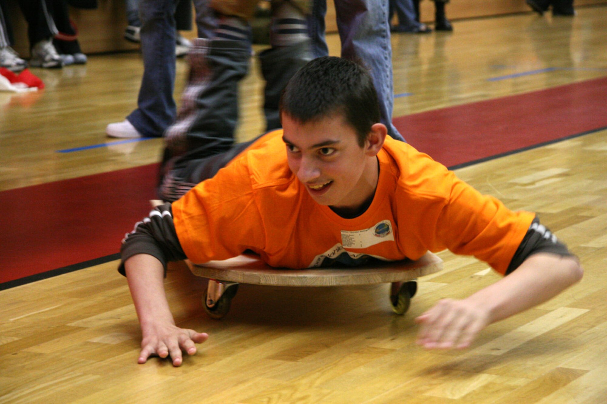 SPANGDAHLEM AIR BASE, Germany – A student prepares for a push board race during Special Children’s Day for special needs students from Bitburg’s St. Martin’s School and local Department of Defense Schools Sept. 20. More than 300 base volunteers stepped-up to make St. Martin’s Special Children’s Day a success. (U.S. Air Force photo/Capt. Lisa Barber)