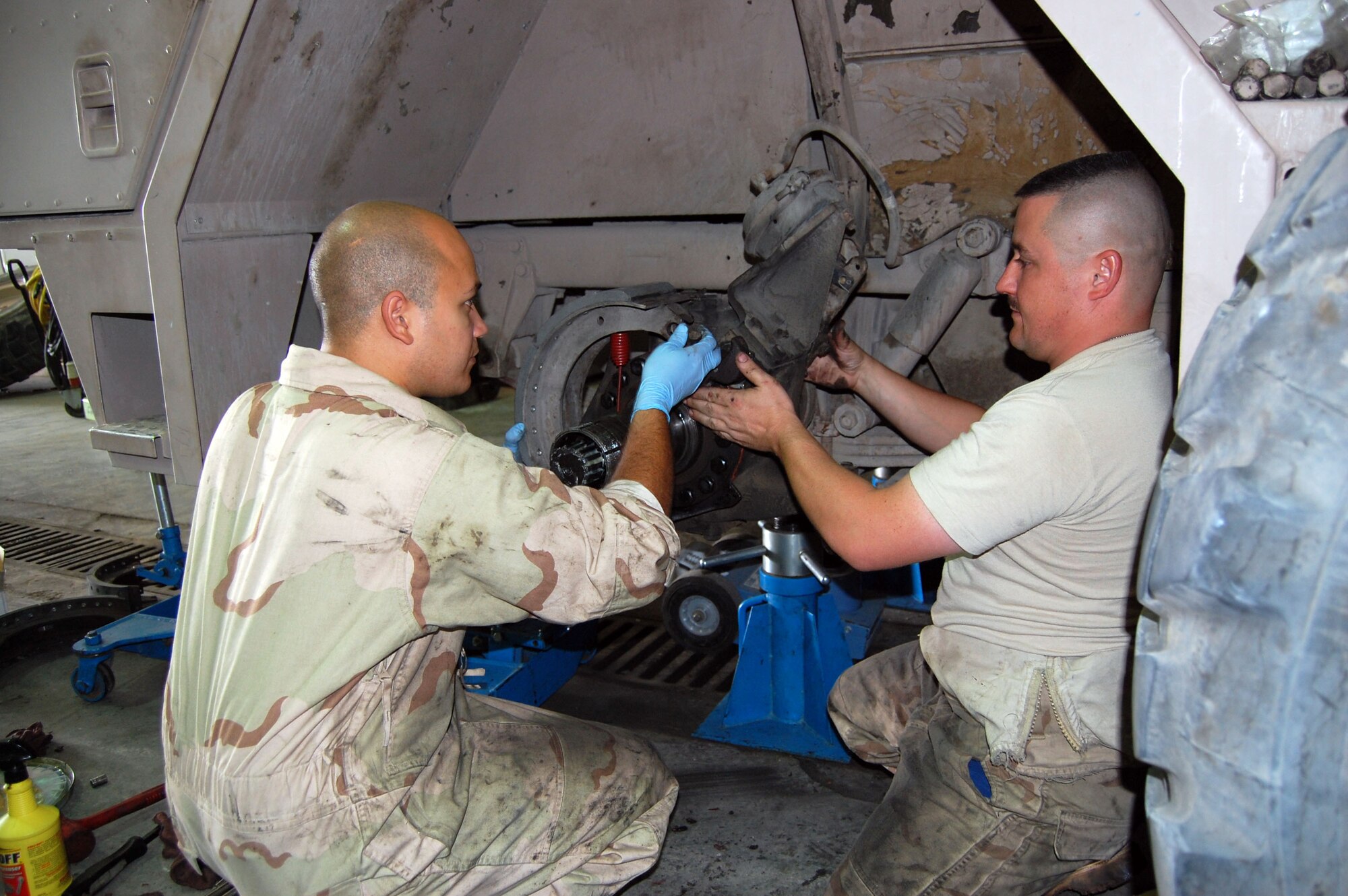 Left: Senior Airman Emmanuel Colon and Tech. Sgt. Thomas Wheeler, 386th Expeditionary Logistics Readiness, vehicle maintenance technicians, replace the break shoes on a fire truck Sept. 24 in the transportation garage. These massive break shoes are specially designed to stop the immense weight of a fully loaded fire truck. (Photo by Staff Sgt. Phillip Butterfield)