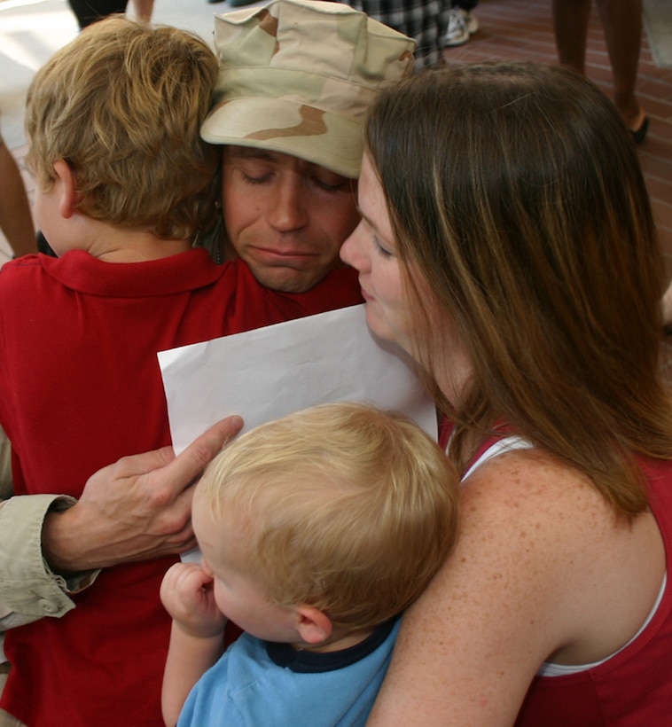 Tech. Sgt. Robert Sanderson, a medical technician with the 82nd Medical Operations Squadron, hugs his wife, Victoria, and his sons, Seth and Brandon.  Sergeant Sanderson was among the 82nd Medical Group and 882nd Training Group medics who returned Sept. 22 from a four-month deployment to Balad Air Base, Iraq. (U.S. Air Force photo/Staff Sgt. Tonnette Thompson)