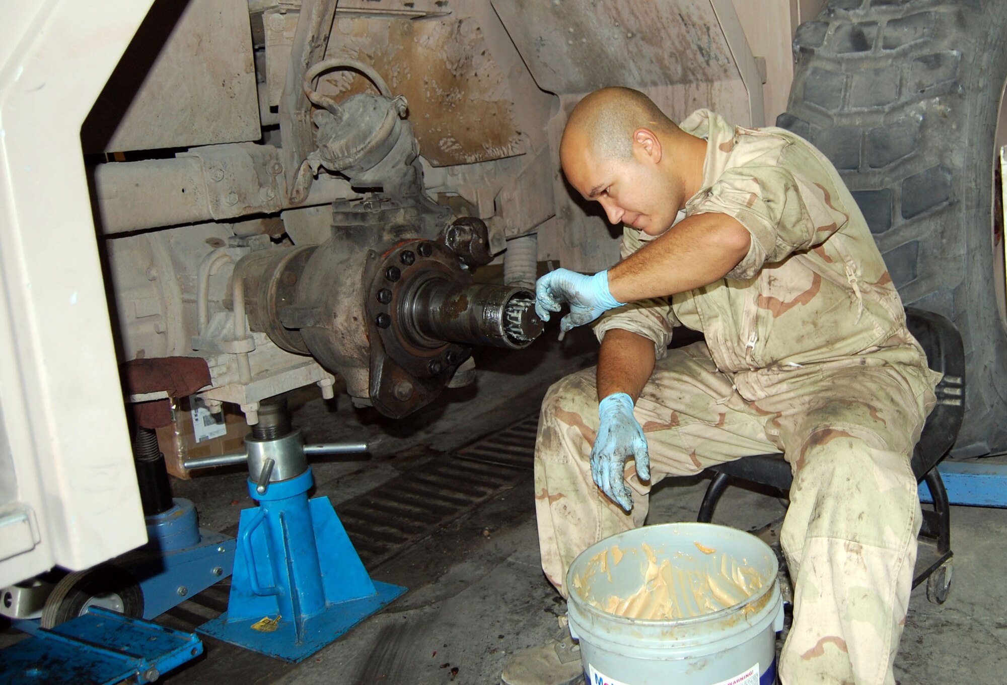 Senior Airman Emmanuel Colon, 386th Expeditionary Logistics Readiness, vehicle maintenance technician, greases splined gears of a fire truck Sept. 24 in the transportation garage. Technicians detected a gear problem during a scheduled brake change. (Photo by Staff Sgt. Phillip Butterfield)