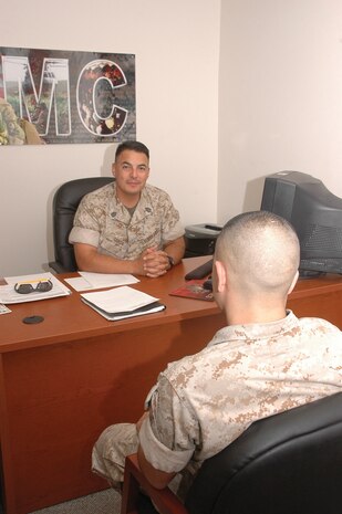 Gunnery Sgt. Johnny Garcia, Headquarters & Headquarters Squadron legal chief, counsels another Marine Sept. 24 here. Garcia believes Hispanic Heritage Month is something to take pride in and that people need to always remember their family and culture.