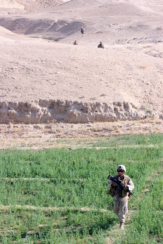 EXPEDITIONARY PATROL BASE - DULAB, Iraq, (Sept. 26, 2007) – Marines with Company A, 1st Battalion, 7th Marine Regiment, Regimental Combat Team 2, return from the open desert after a long morning of laying in an over watch position for a vehicle checkpoint near the Euphrates River. The VCP is part of the battalion’s strategy to counter a suspected increase of enemy activity during the Muslim holy month of Ramadan. Official Marine Corps Photo By Cpl. Ryan C. Heiser.