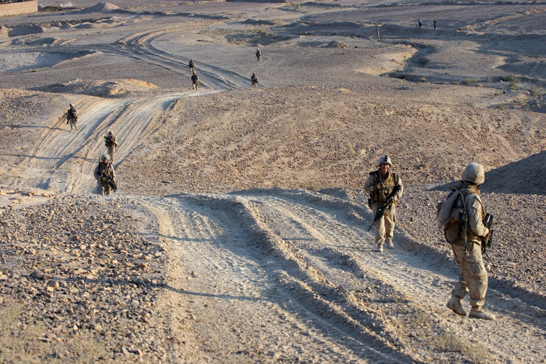 EXPEDITIONARY PATROL BASE - DULAB, Iraq, (Sept. 26, 2007) – Marines with 1st Platoon, Company A, 1st Battalion, 7th Marine Regiment, Regimental Combat Team 2, climb up one of the steep hills on the edge of town on their way to an aver watch position. The Marines of Company A, known as the “Animals,” spend most of their time on foot patrols in or around the city, or in over watch positions for Iraqi Security Forces. Official Marine Corps Photo By Cpl. Ryan C. Heiser.