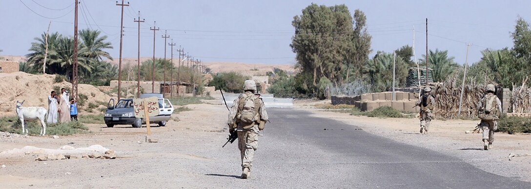 EXPEDITIONARY PATROL BASE - DULAB, Iraq, (Sept. 26, 2007) – Marines with 1st Platoon, Company A, 1st Battalion, 7th Marine Regiment, Regimental Combat Team 2, patrol through the city streets. The company, known as the Animals, frequently goes on patrols lasting more than six hours, and regularly covers a dozen miles each day. Official Marine Corps Photo By Cpl. Ryan C. Heiser.