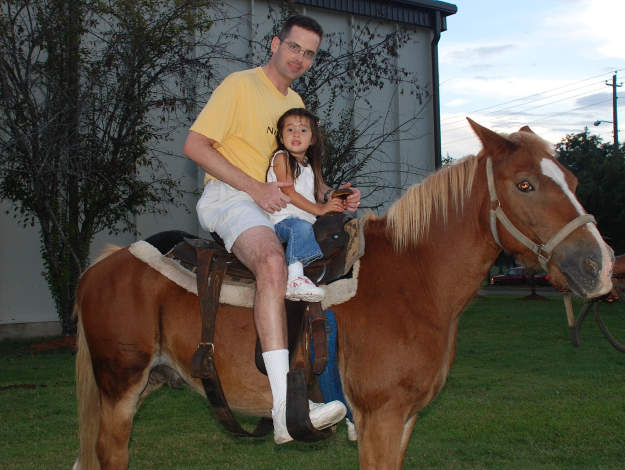 Lieutenant Col. Martin Giacobbi, 14th Medical Operations Squadron, and his daughter, Angela, ride a horse Monday night at the Family Fall Festival at the Columbus Club. (U.S. Air Force photo by Pam Wickham)