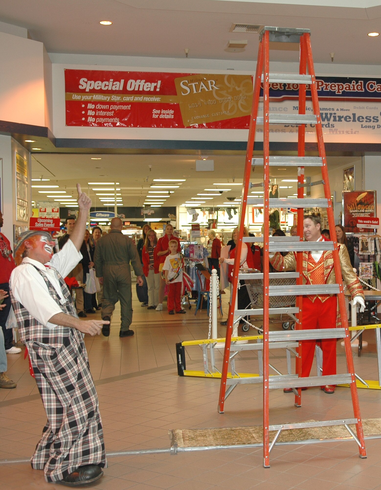 FAIRCHILD AIR FORCE BASE, Wash. – Mitch Freddes, a clown from Colorado performing with the Ringling Brothers and Barnum and Bailey circus, encourages Jon Weiss, a circus host, to balance the taller ladder on his chin for the amusement of members of Team Fairchild at a free performance Sept. 20 in the Fairchild Exchange. (U.S. Air Force photo / Airman 1st Class Kali L. Gradishar)