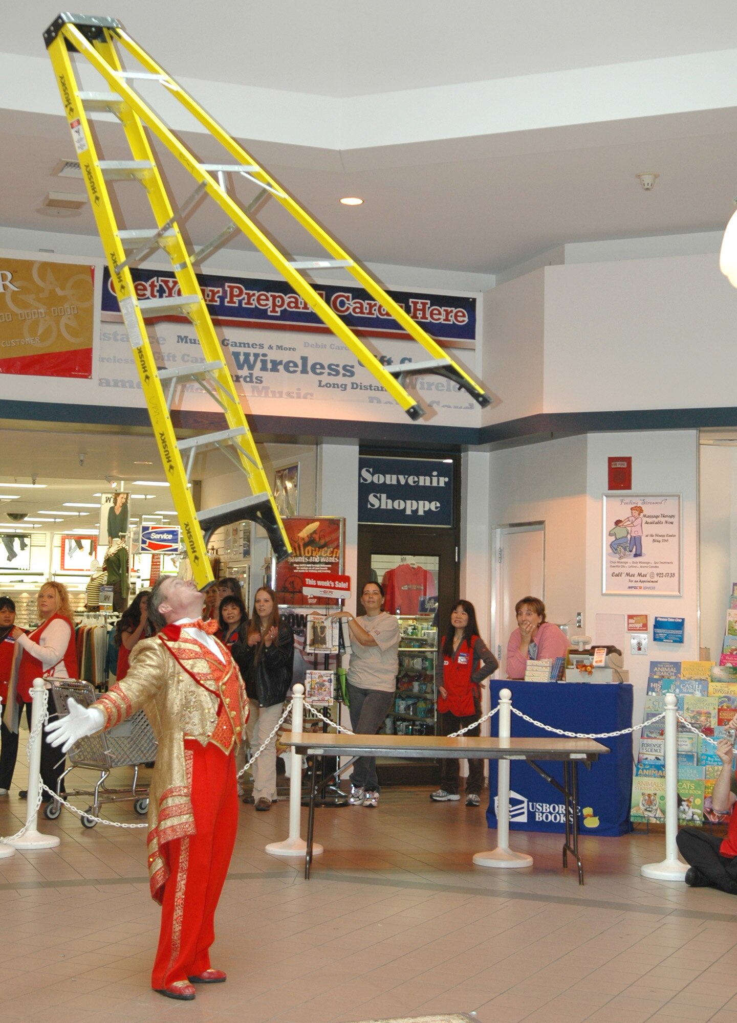FAIRCHILD AIR FORCE BASE, Wash. – Ringling Brothers and Barnum and Bailey circus host, Jon Weiss from New York, balances a ladder on his chin for an audience of young and old alike at the Fairchild Exchange Sept. 20. “This is our way of giving a little back,” said Mr. Weiss of the free performance open to members of Team Fairchild. (U.S. Air Force photo / Airman 1st Class Kali L. Gradishar)