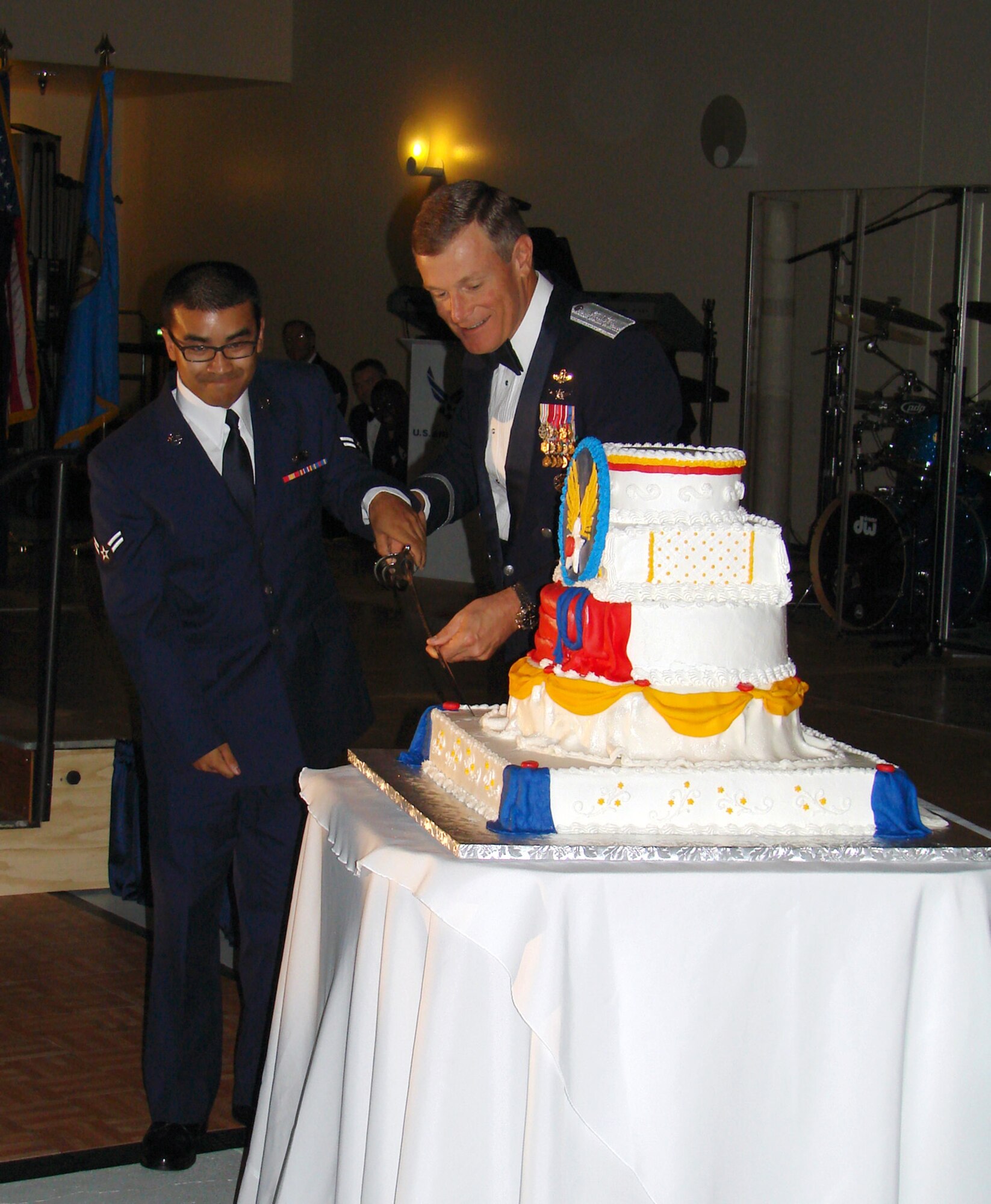 Maj. Gen. Irv Halter, 19th Air Force commander, and Airman 1st Class Sean Noble, 71st Mission Support Squadron personnelist, use a saber to cut the birthday cake at the Air Force 60th birthday celebration Saturday night at Cherokee Strip Conference Center. More than 390 attendees were treated to rousing tributes to the Air Force and Oklahoma, dining and dancing and a guest speech by Maj. Gen Irv Halter, 19th Air Force commander. Top officials from the base, the State of Oklahoma and the City of Enid attended the gala in downtown Enid to commemorate 60 year of an independent Air Force, 66 years of history at Vance and 100 years of heritage of the State of Oklahoma.  (Air Force photo by Capt. Tony Wickman)