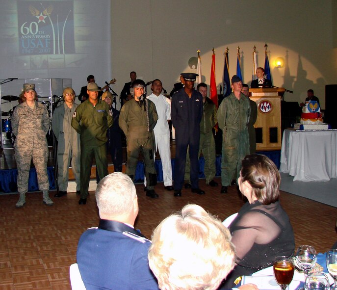 Air Force 60th birthday celebration attendees review historical uniforms worn by current Team Vance members during the celebration Saturday night at the Cherokee Strip Conference Center. More than 390 attendees were treated to rousing tributes to the Air Force and Oklahoma, dining and dancing and a guest speech by Maj. Gen Irv Halter, 19th Air Force commander. Top officials from the base, the State of Oklahoma and the City of Enid attended the gala in downtown Enid to commemorate 60 year of an independent Air Force, 66 years of history at Vance and 100 years of heritage of the State of Oklahoma. (Air Force photo by Capt. Tony Wickman)