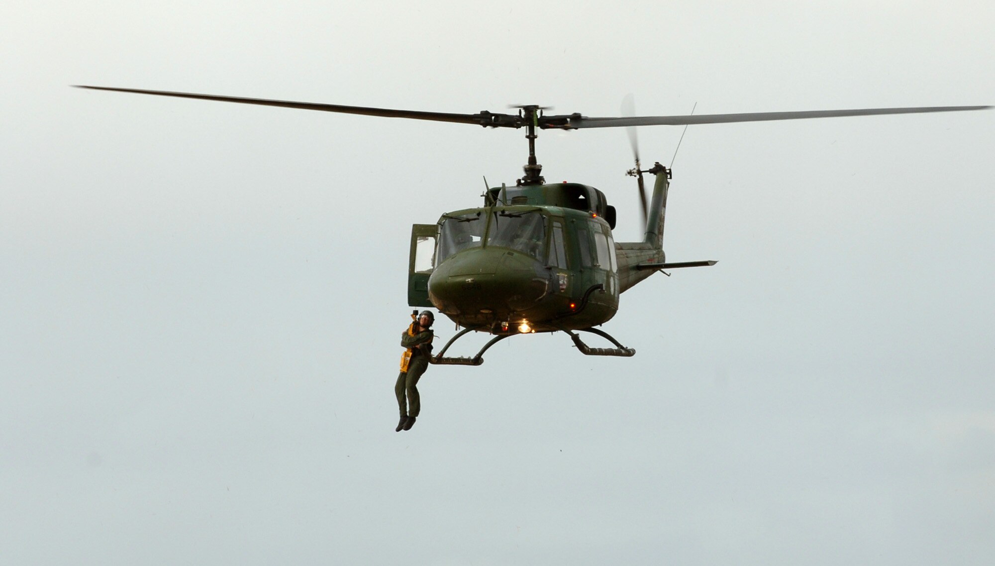 FAIRCHILD AIR FORCE BASE, Wash. – Senior Airman Brian Daubert, Survival, Evasion, Resistance and Escape specialist here, is hoisted into a helicopter during a combat search and rescue demonstration. Weekly demonstrations give students a chance to see firsthand the techniques they’ve learned in the SERE classroom, such as using the parachute descent checklist. (U.S. Air Force photo/Airman 1st Class Jocelyn Ford)