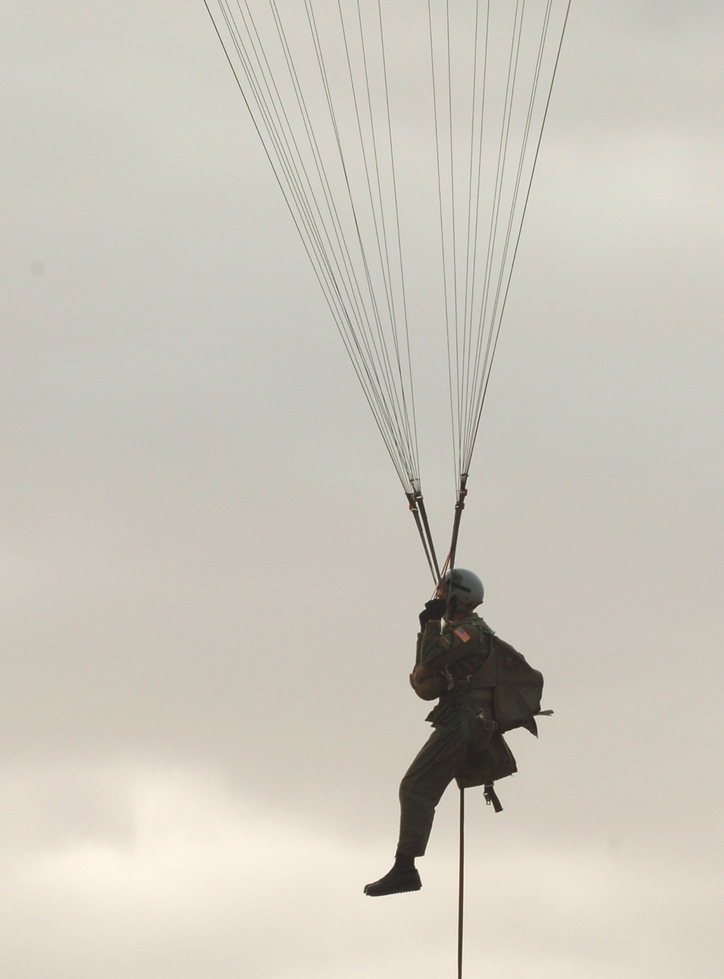 FAIRCHILD AIR FORCE BASE, Wash. – Survival, Evasion, Resistance and Escape instructors here perform weekly parachute jump demonstrations for SERE students. Here, Senior Airman Brian Daubert, SERE specialist, prepares to land during a combat search and rescue demo, demonstrating performance capabilities of the C-9 emergency egress parachute and giving students a real-world look at handling the chute. (U.S. Air Force photo/Airman 1st Class Jocelyn Ford)