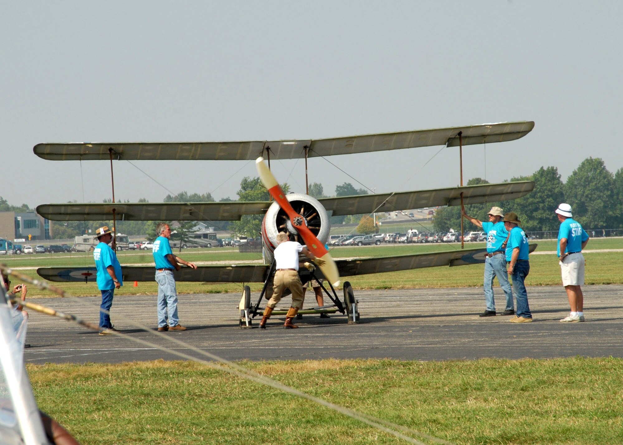 A ground crew attempts to start a Sopwith triplane while spectators watch at the Dawn Patrol Rendezvous World War I Fly-In Sept. 22 on the grounds of the National Museum of the United States Air Force in Dayton, Ohio. Activities included period re-enactors in a war encampment setting, era automobiles on display and participating in a parade, flying exhibitions by WWI radio-controlled aircraft, and a collector's show for WWI items.  (U.S. Air Force photo/Staff Sgt Joshua Strang)