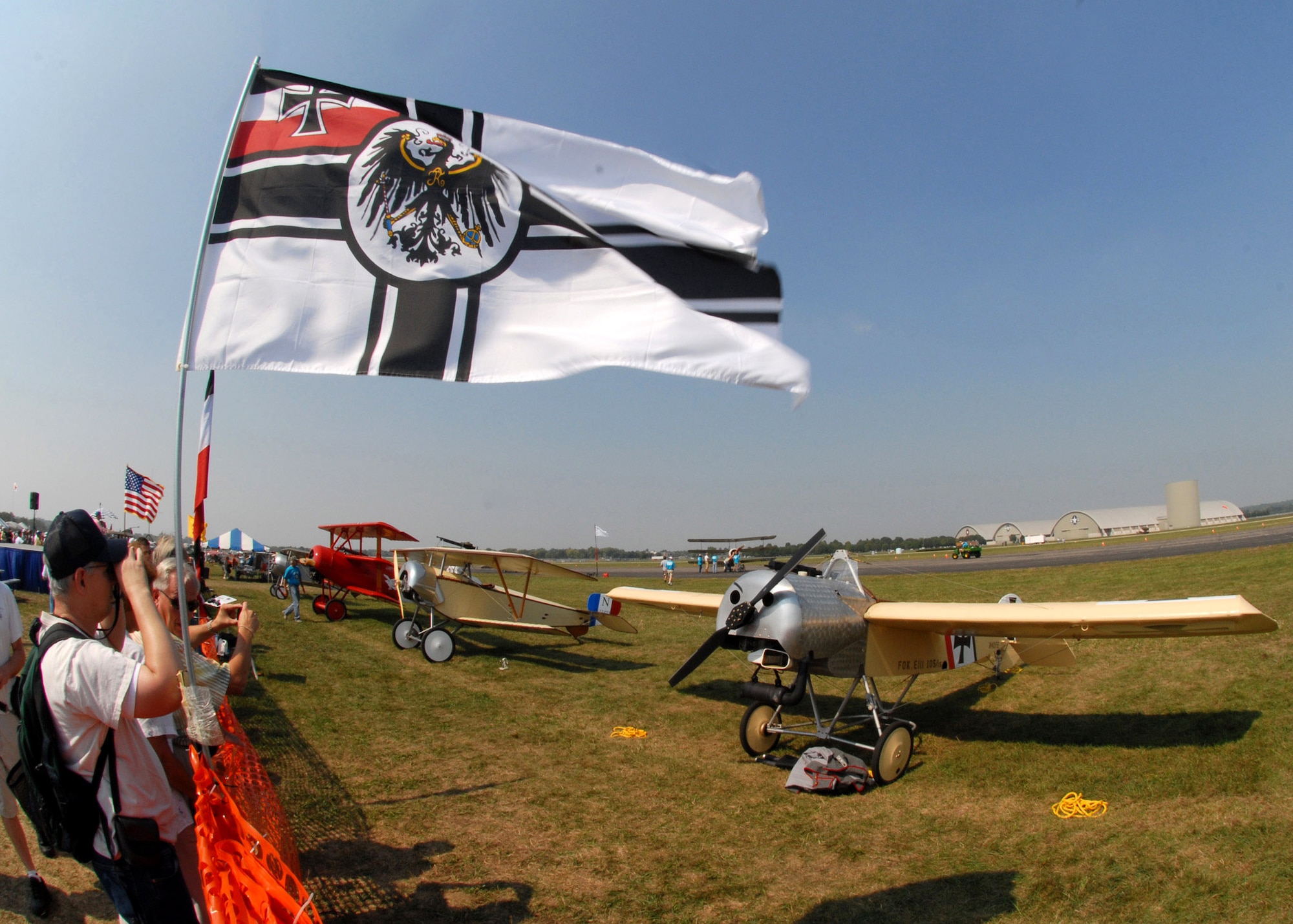 Out on the runway (in backbround) a ground crew attempts to start a Sopwith triplane while spectators watch at the Dawn Patrol Rendezvous World War I Fly-In Sept. 22 on the grounds of the National Museum of the United States Air Force in Dayton, Ohio. Activities included period re-enactors in a war encampment setting, era automobiles on display and participating in a parade, flying exhibitions by WWI radio-controlled aircraft, and a collector's show for WWI items.  (U.S. Air Force photo/Staff Sgt Joshua Strang)