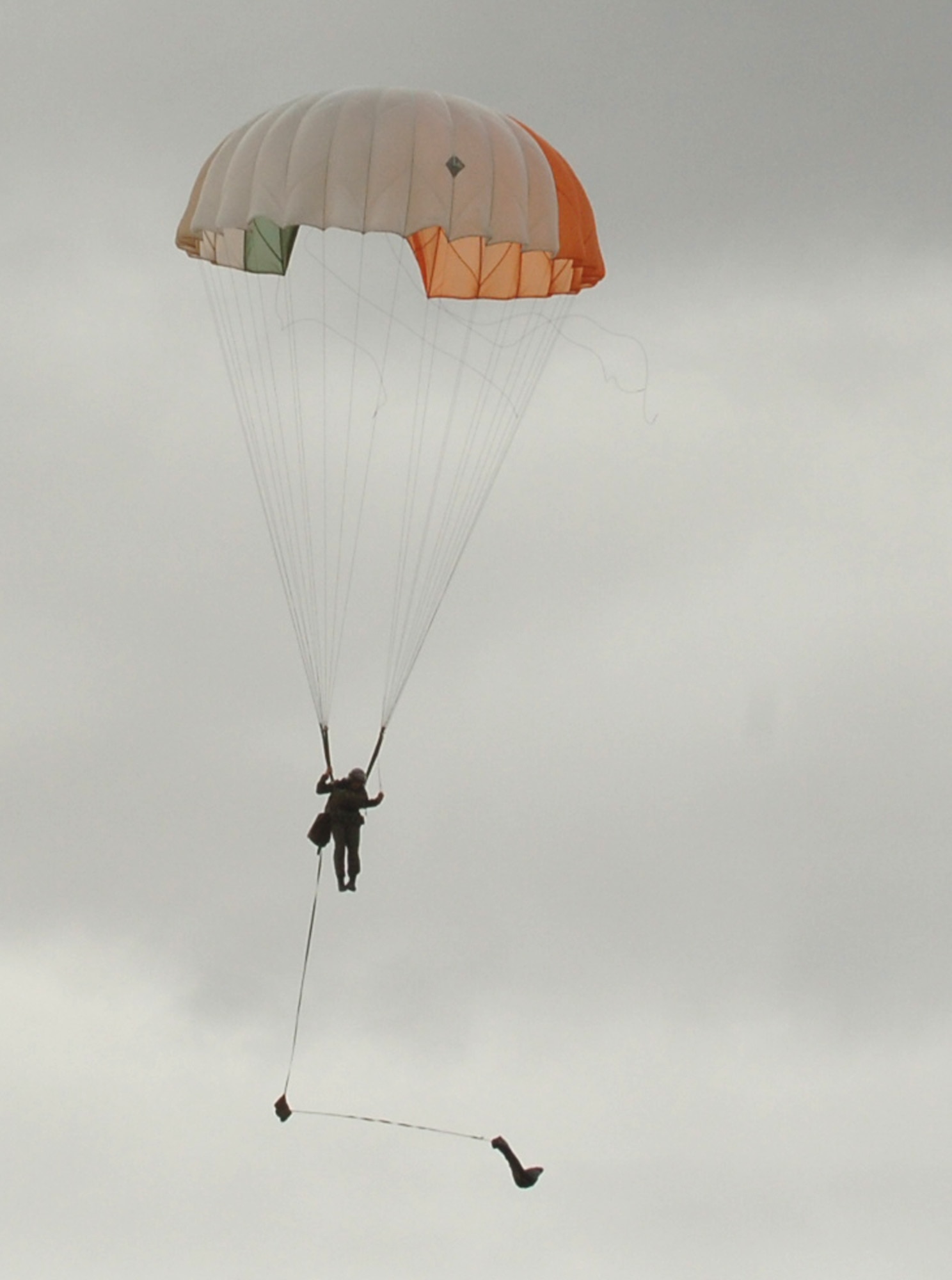 FAIRCHILD AIR FORCE BASE, Wash. – Senior Airman Brian Daubert, Survival, Evasion, Resistance and Escape specialist here, prepares to land during a parachute jump demonstration. Weekly demos show SERE students the performance characteristics of the C-9 emergency egress parachute, and allow students to see firsthand the techniques they’ve learned in the SERE school, such as using the parachute descent checklist. (U.S. Air Force photo/Airman 1st Class Jocelyn Ford)
