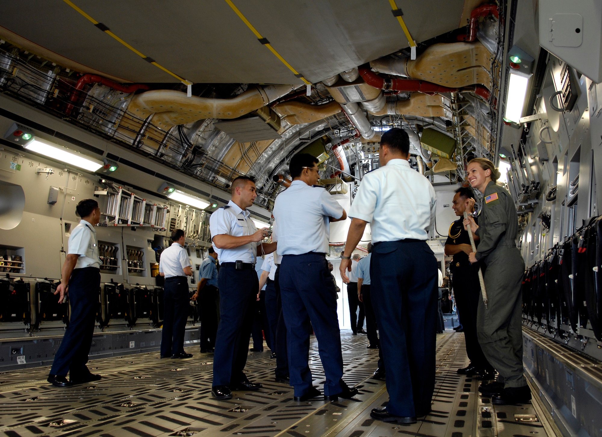Senior Airman Lisa Long discusses the C-17 Globemaster III with members of the Pacific Rim Airpower Symposium, Sept. 20, at Hickam Air Force Base. Officials added a noncommissioned officer's development course to this year's conference.  Airman Long is a loadmaster with the 535th Airlift Squadron. (U.S. Air Force photo/Tech. Sgt. Shane A. Cuomo) 