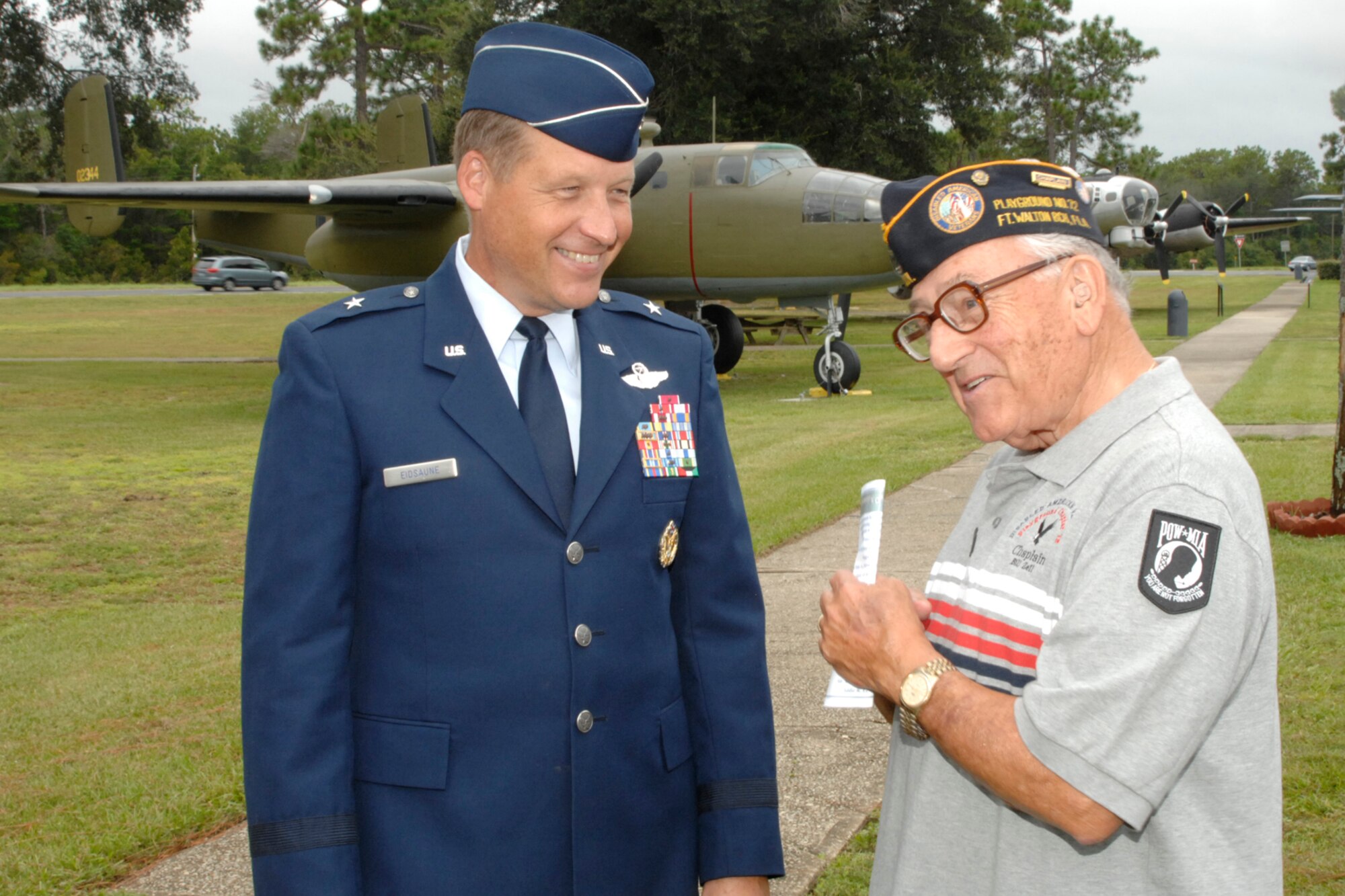 EGLIN AIR FORCE BASE, Fla. -- Brig. Gen. David W. Eidsaune, Air Armament Center commander, retired Chief Master Sgt. Bill Zell talk about the chief's military experiences following annual Prisoner of War Missing in Action Recognition Day ceremony Sept. 21 at the Air Force Armament Museum. The ceremony ended outside the museum with the Addie Lewis Middle School students laying a wreath in honor of our missing comrades, a 21-gun salute and taps. Chief Zell is the chaplain of the Disabled Veterans Playground Chapter 72 located in Ft. Walton Beach, Fla. (U.S. Air Force photo by Mike Fleck)