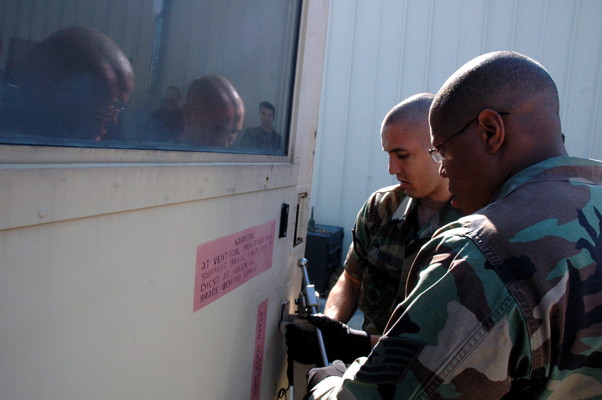 Students in the Advanced Mobile Command and Control Communications Course work on a Mark shelter during training for the course Sept. 25, 2007, at Fort Dix, N.J.  The course is taught by the U.S. Air Force Expeditionary Center's Mobility Operations School.  (U.S. Air Force Photo/Tech. Sgt. Scott T. Sturkol)