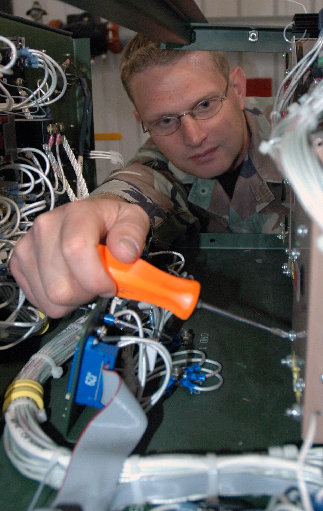 Staff Sgt. Jonathon McClure, course director for the Mobility Operations School Mobile Command and Control Environmental Control Unit Course and an instructor for the Mobile C-2 Generator Course, works on a generator in his training facility preparing it for the next course Sept. 25, 2007, at the U.S. Air Force Expeditionary Center on Fort Dix, N.J.  Sergeant McClure's instruction for mobile command and control Airmen prepare them for ground operations in a deployed environment.  (U.S. Air Force Photo/Tech. Sgt. Scott T. Sturkol)
