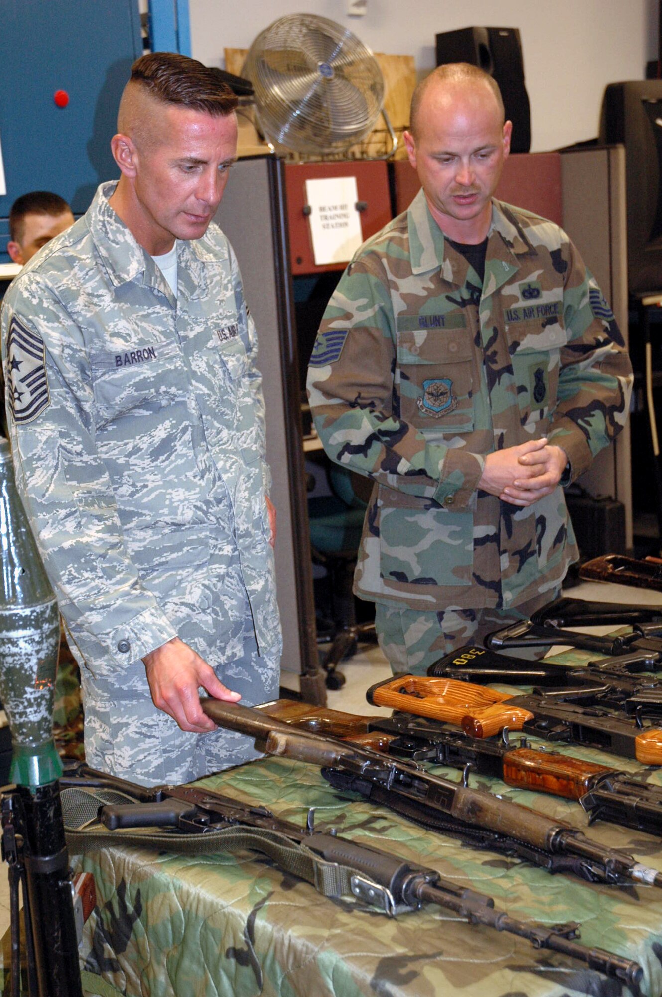 Tech. Sgt. Charles Glunt, U.S. Air Force Expeditionary Center armory and a combat arms instructor, shows Chief Master Sgt. Joseph Barron Jr., Air Mobility Command's command chief master sergeant, some of the weapons used for training at the USAF EC Sept. 18, 2007, on Fort Dix, N.J.  The Center's armory has the Air Force's largest collection of foreign weapons on the East Coast and Chief Barron was able to see numerous models of those foreign weapons.  (U.S. Air Force Photo/Tech. Sgt. Scott T. Sturkol)