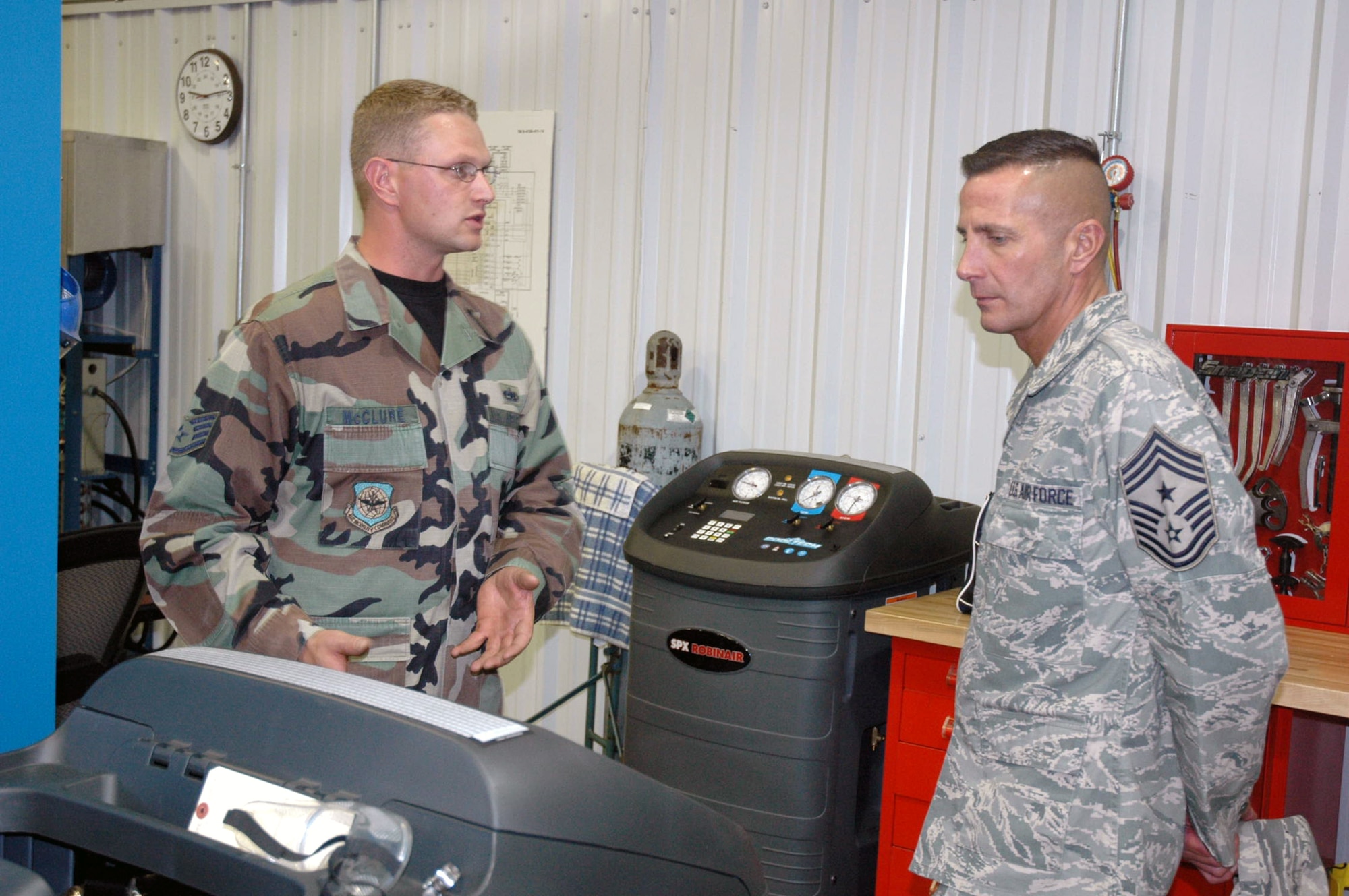 Staff Sgt. Jonathon McClure, U.S. Air Force Expeditionary Center Mobility Operations School, shows Chief Master Sgt. Joseph Barron Jr., Air Mobility Command's command chief master sergeant, some of the equipment used in his classroom area during an official visit and tour by Chief Barron to the Center Sept. 18, 2007, at Fort Dix, N.J.  (U.S. Air Force Photo/Tech. Sgt. Scott T. Sturkol)