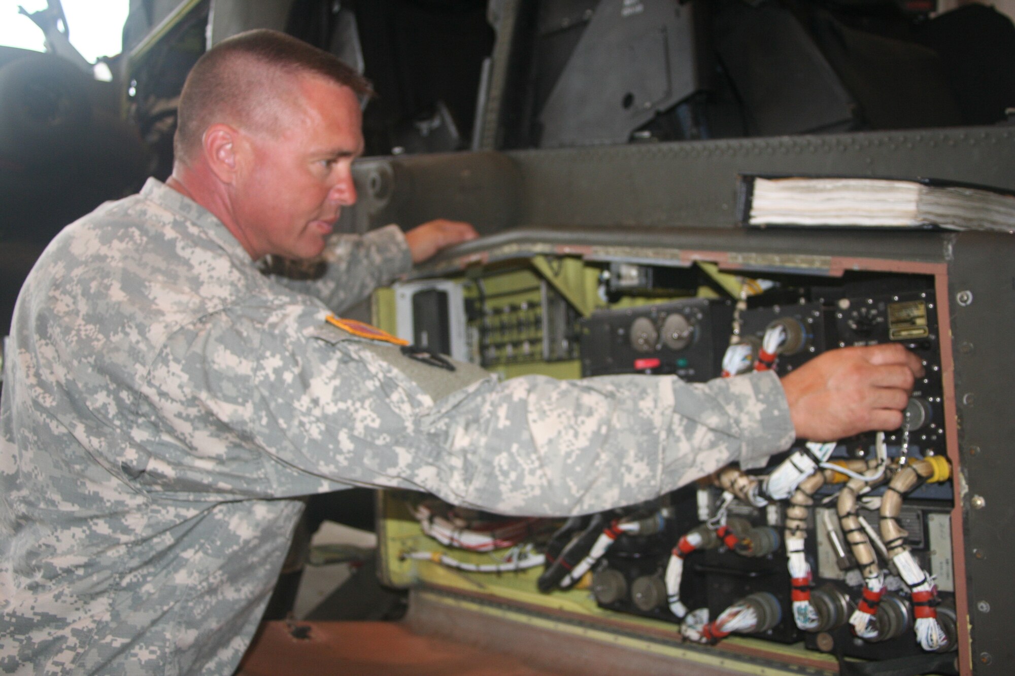 1st Sgt. David Gail, of the Missouri National Guard's 135th Attack Battalion, performs a systems check on an AH-64 Apache helicopter Sept. 25. Sergeant Gail recently was awarded the Bronze Star Medal for Meritorious Achievement during his tour to Iraq. (Air Force photo/Staff Sgt. Rob Hazelett)