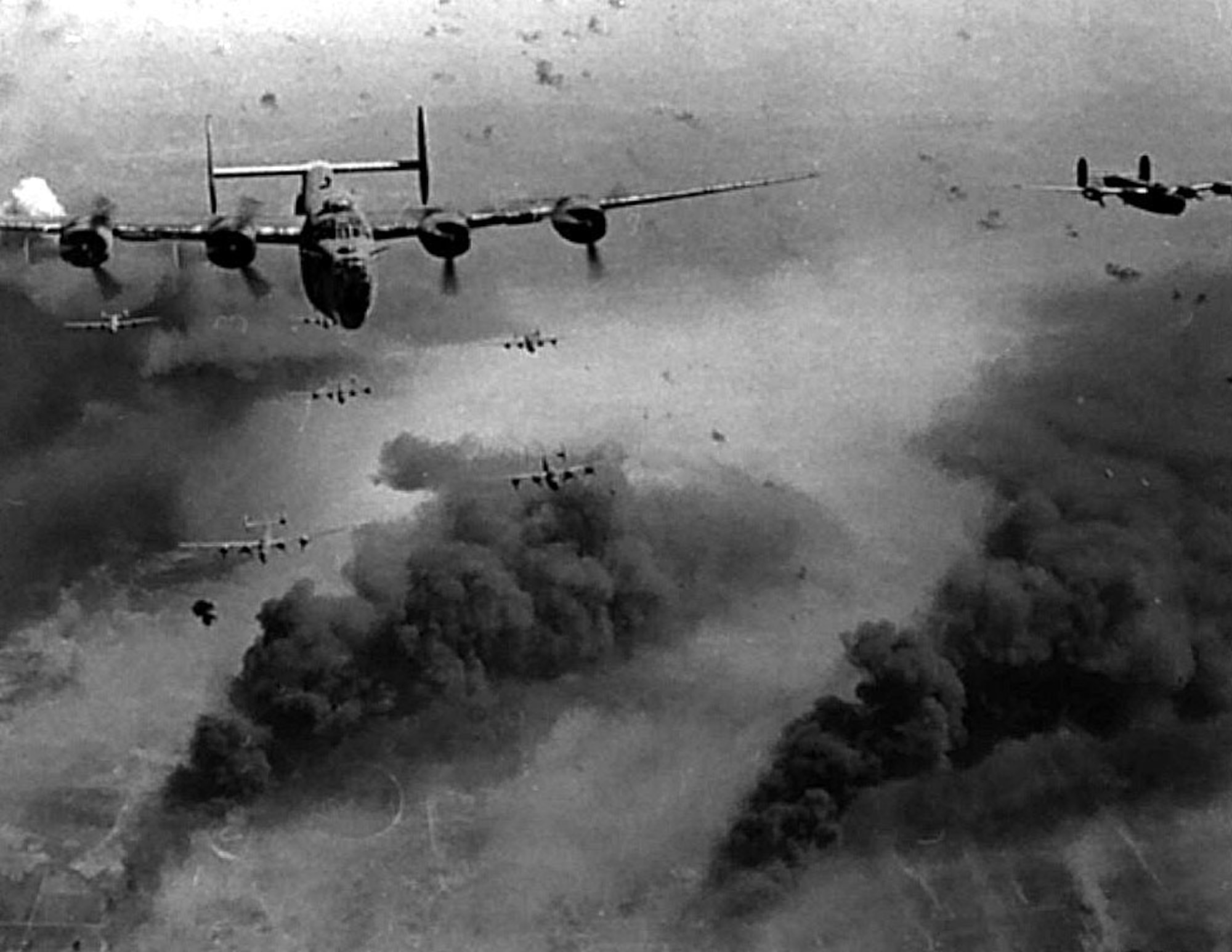A formation of B-24 Liberators conduct a bombing mission over occupied Europe during World War II.  (U.S. Air Force photo)