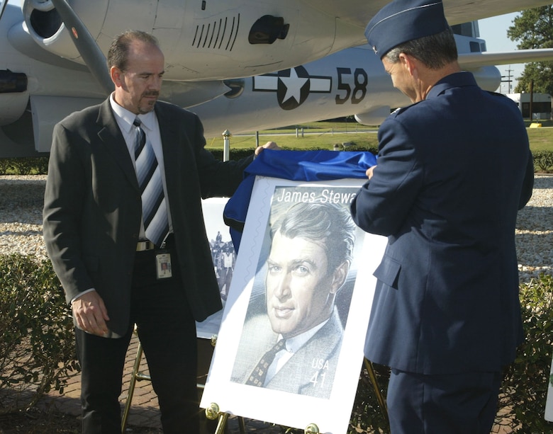 Mr. Bob Hopkins (left), of the U.S. Postal Service of Marietta, and Col. Joseph Thomas, 94th Airlift Wing vice commander, unveiled a picture of the new 41 cent stamp honoring Brig. Gen. James Stewart, B-17 and B-24 bomber pilot on September 18.  The unveiling was part of the Air Force 60th anniversary celebration at Dobbins Air Reserve Base.  (U.S. Air Force photo/Don Peek)