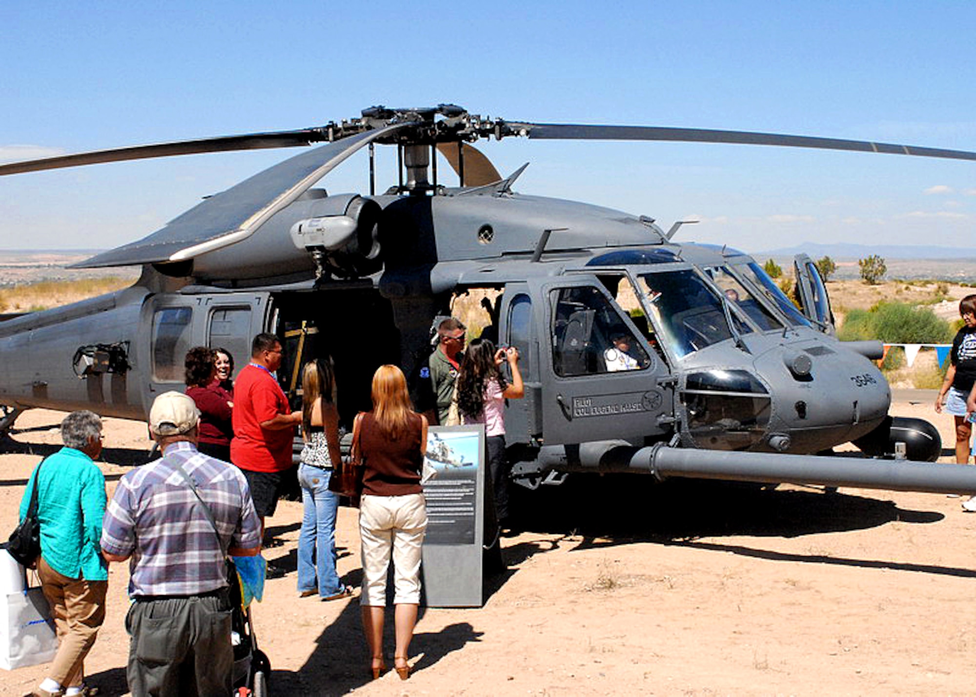 Members of the Albuquerque community tour a static display of an HH-60 Pave Hawk from the 58th Special Operations Wing, Kirtland AFB, N. M., as part of the outdoor exhibits and static displays of the New Mexico Air Force BAses 60th Anniversary Celebration at the Sandia Resort, Sept. 14. U.S. Air Force photo by Dennis Carlson
