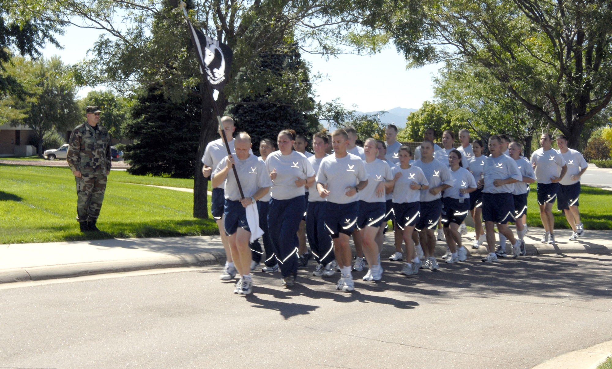 A flight if Airmen carry the POW/MIA flag to the chapel Sept. 21 as part of the POW/MIA Day ceremony. (U.S. Air Force photo by Roberta McDonald)