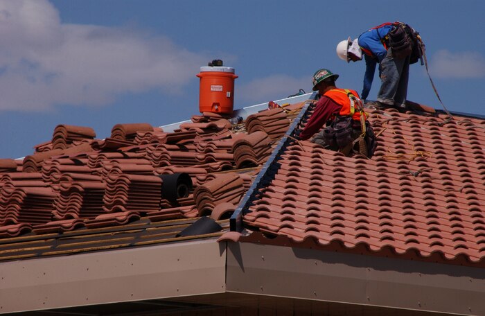A contracted construction crew finishes roof work of the new Bio-Environmental facility here, Sept. 21. The project is one element of more than 50 projects currently underway as part of an ongoing construction effort to address Nellis’ mission, quality of life and environmental needs. (U.S. Air Force photo by Staff Sgt. Jacob R. McCarthy)