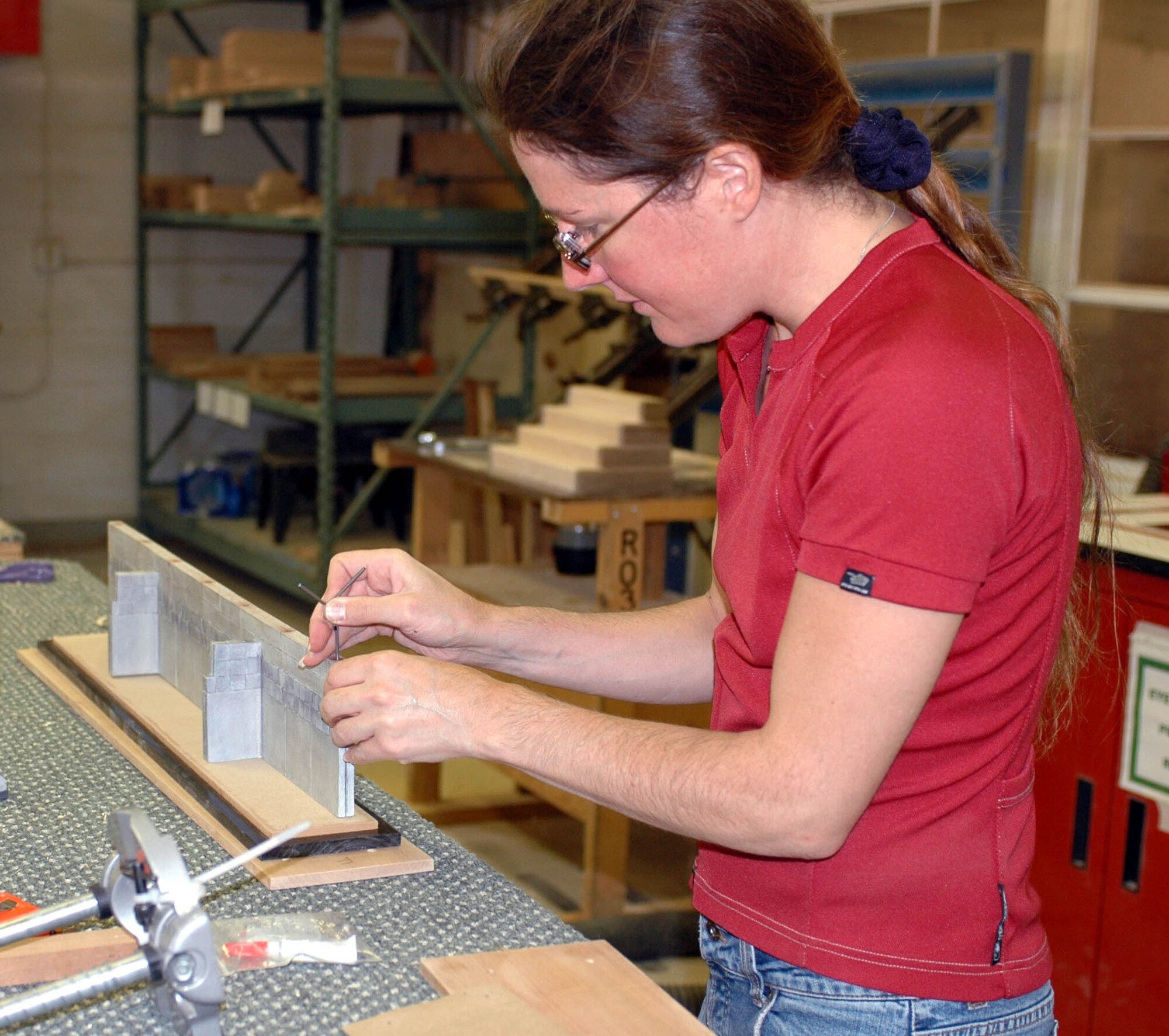 Erika La Tour Eiffel inserts a post into the top of one of her models of the Berlin Wall. The Travis Arts and Crafts Center also makes shadowboxes, flag boxes, coin racks and awards boards and is open Tuesday through Friday from 10:30 a.m. to 6 p.m. The shop offers "do-it-yourself" hours Wednesdays from 10:30 a.m. to 6 p.m. (U.S. Air Force photo/Nick DeCicco)
